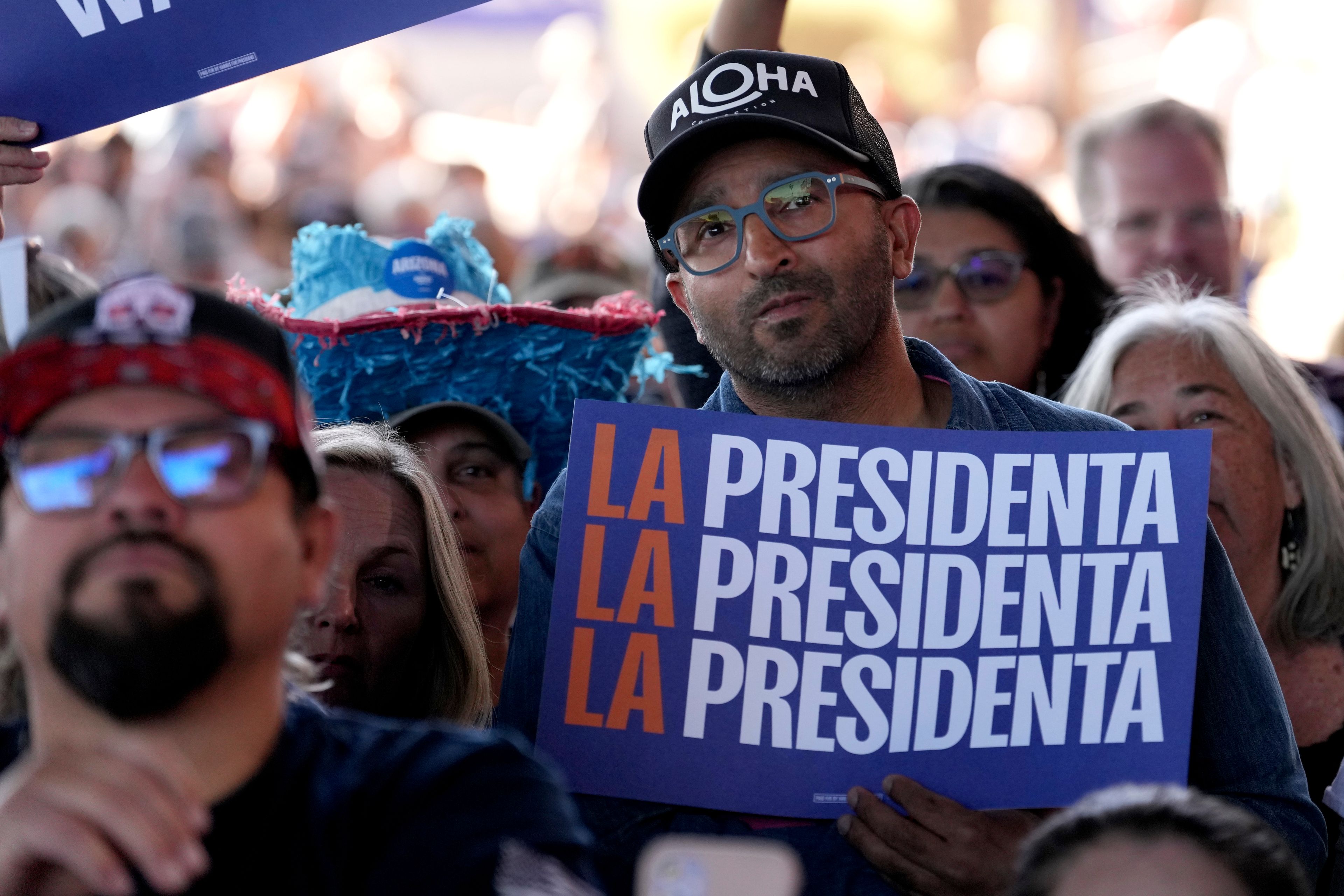 A supporter holds a sign as Democratic presidential nominee Vice President Kamala Harris speaks during a campaign event at Talking Stick Resort Amphitheatre, Thursday, Oct. 31, 2024, in Phoenix. (AP Photo/Ross D. Franklin)