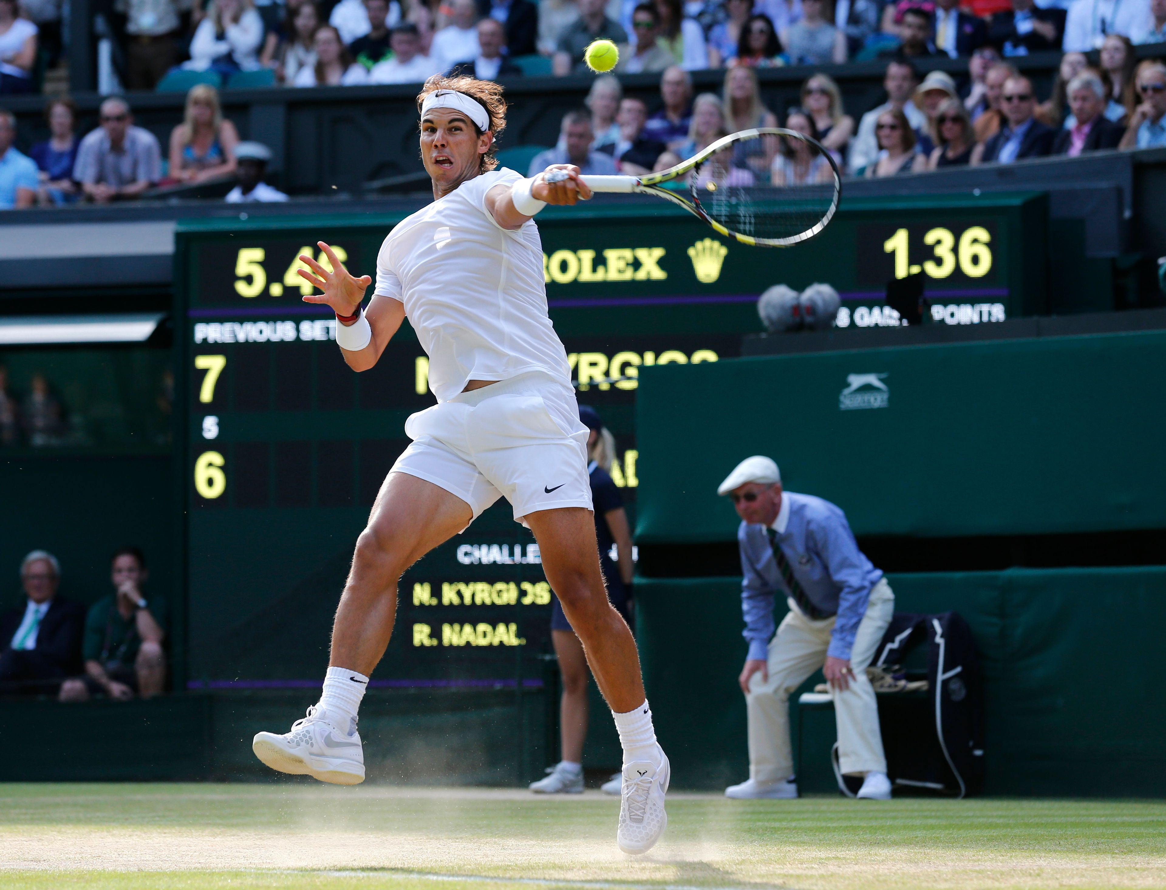 FILE - Rafael Nadal of Spain leaps as he plays a return to Nick Kyrgios of Australia during their men's singles match at the All England Lawn Tennis Championships in Wimbledon, London, Tuesday, July 1, 2014, as he has announced he will retire from tennis at age 38 following the Davis Cup finals in November. (AP Photo/Ben Curtis, File)