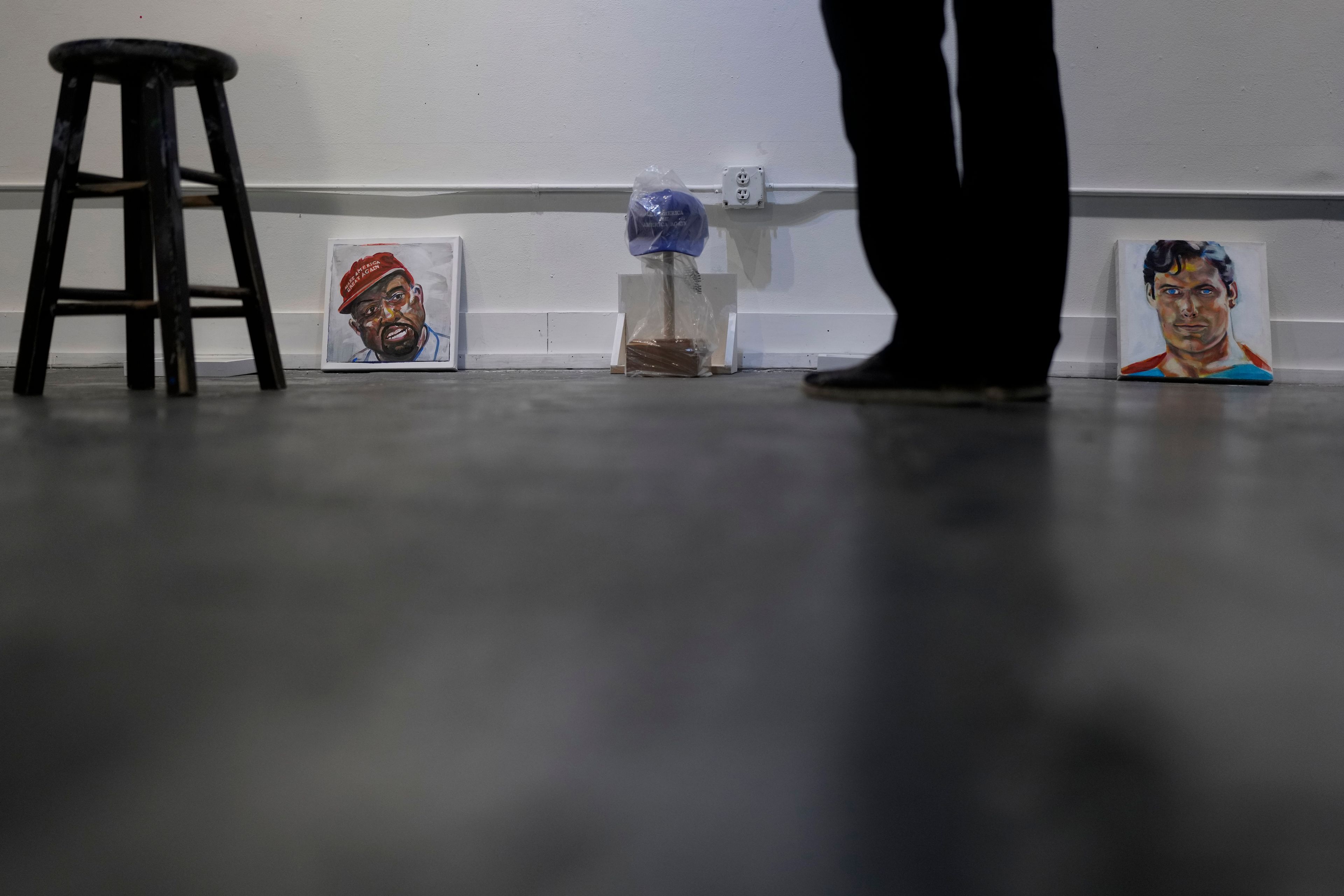 Artist David Alcantar prepares works of art from his "Superman Project" for an upcoming show in San Antonio, Monday, Sept. 30, 2024. (AP Photo/Eric Gay)