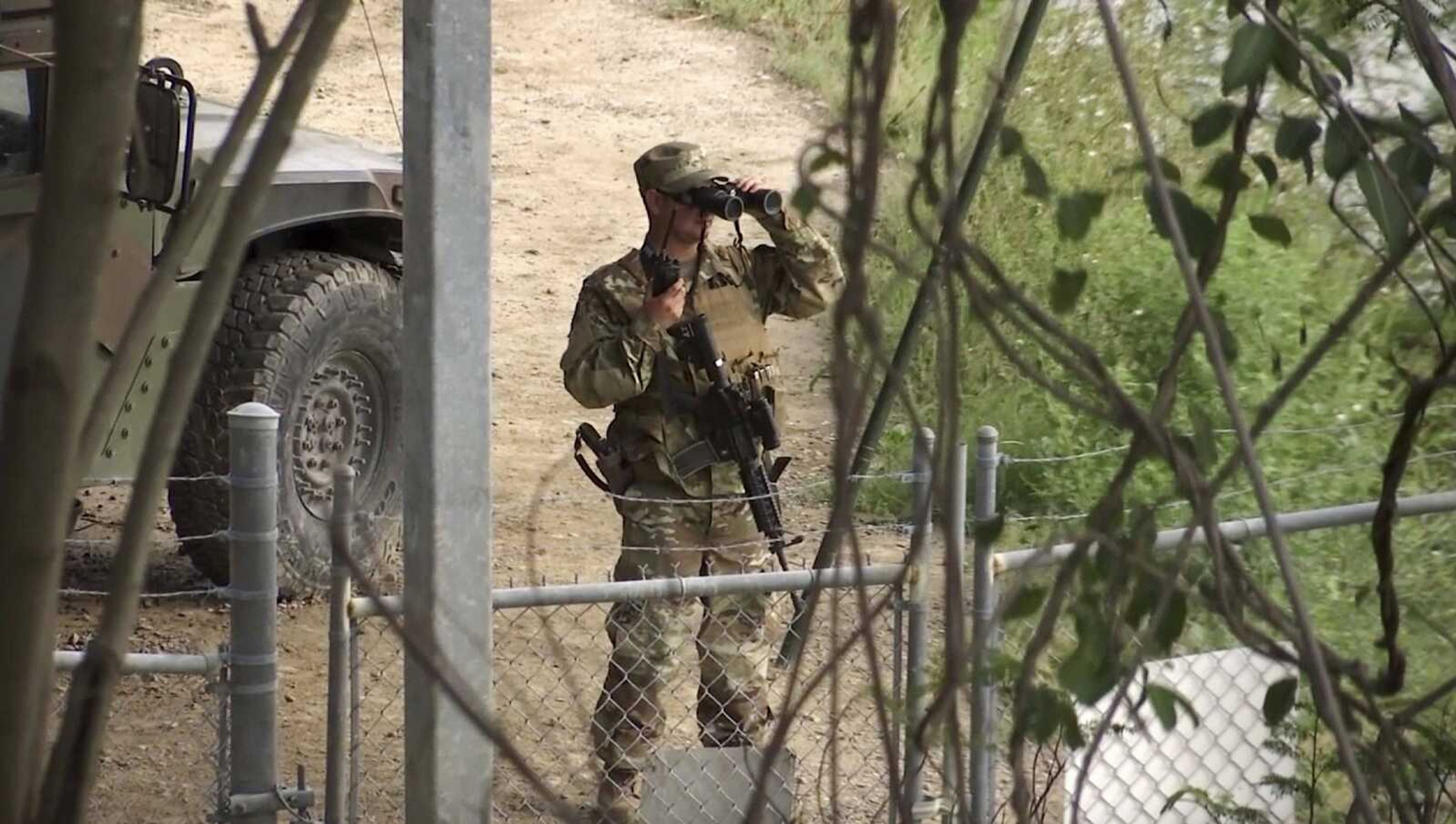 A National Guard soldier watches Tuesday over the Rio Grande River on the border in Roma, Texas.