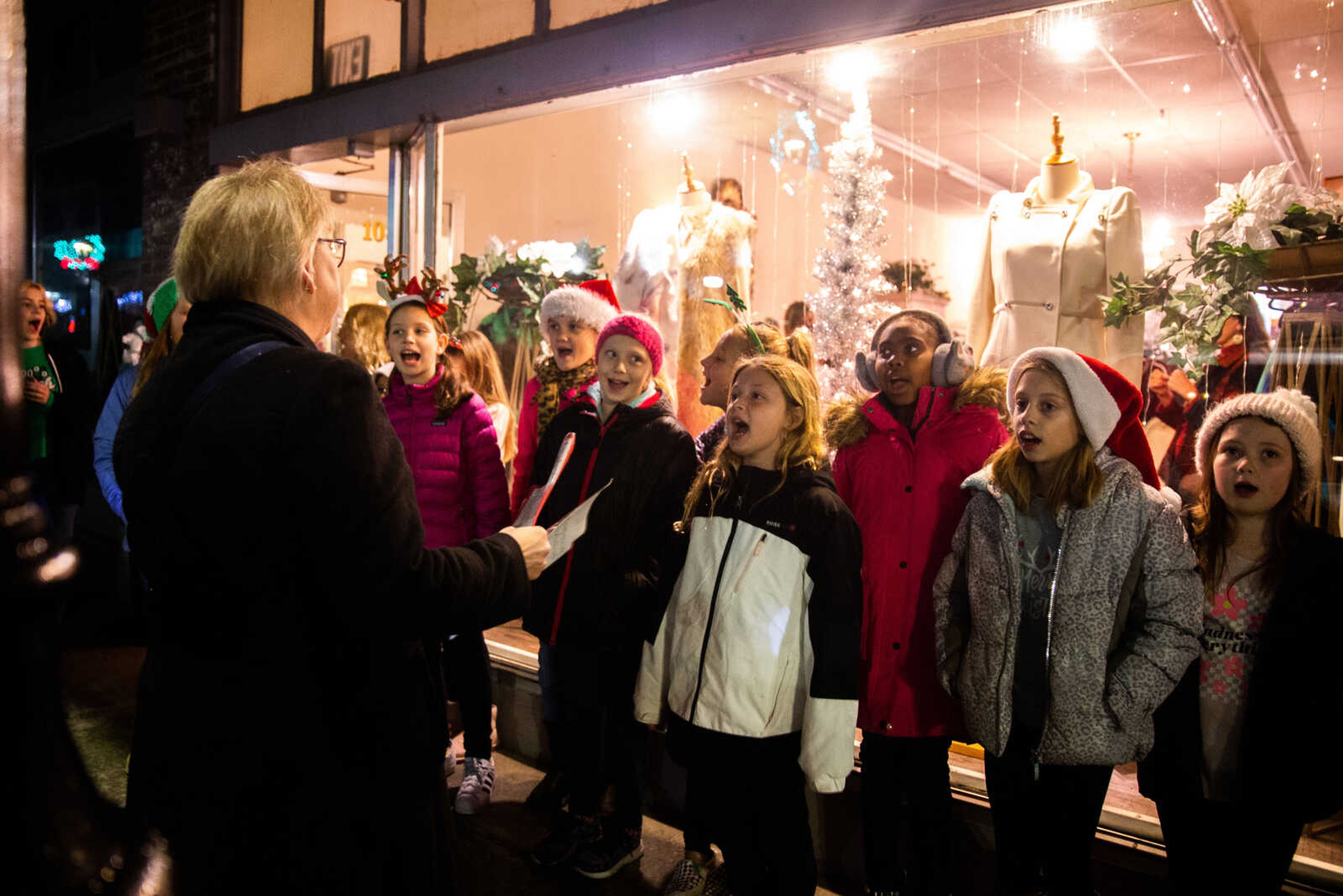 Rebecca Gentry leads the 4th grade choir from Alma Schrader Elementary School as they carol along Main Street&nbsp;&nbsp;on Friday, Dec. 2 in downtown Cape Girardeau.