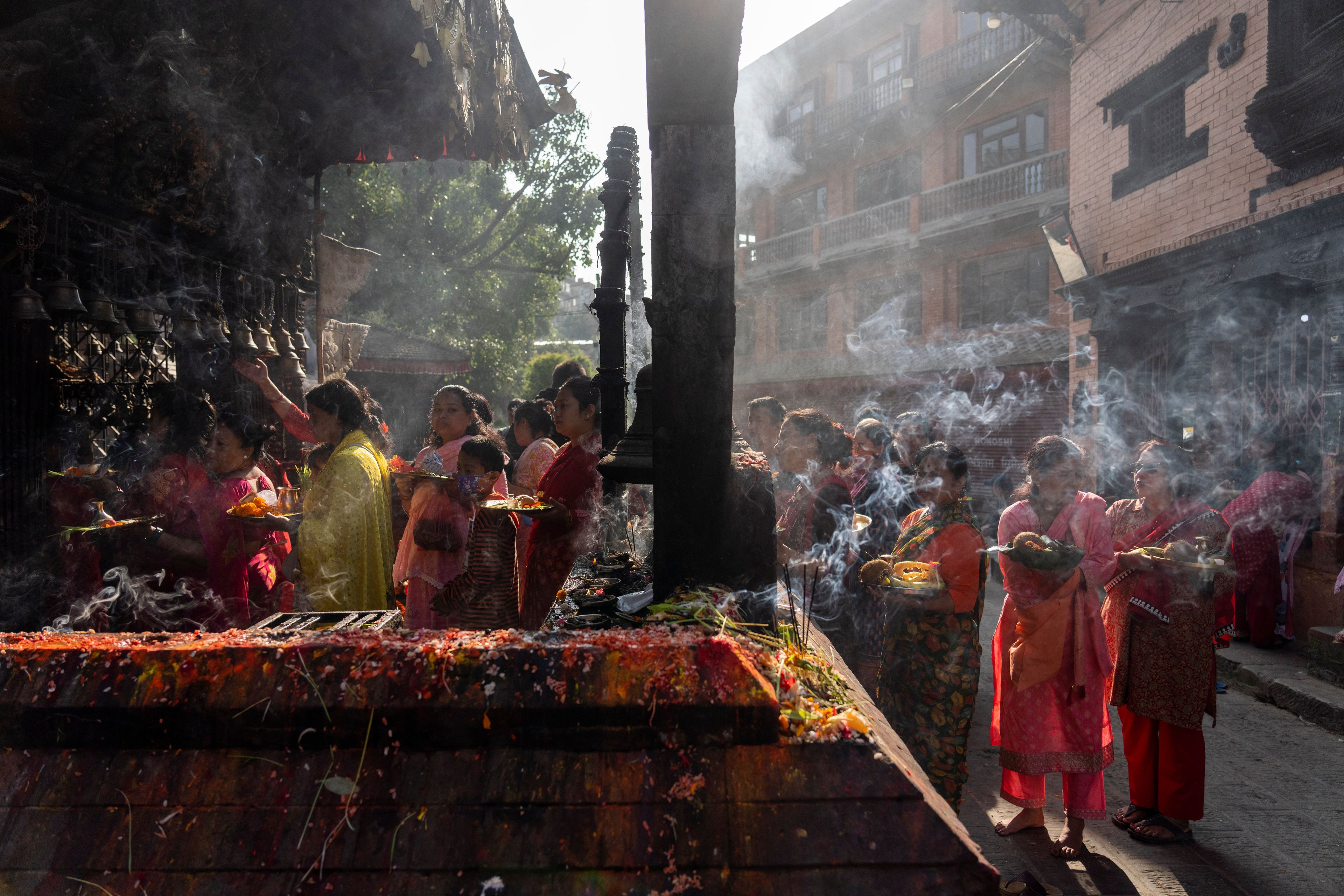 Devotees wait to perform rituals inside the Siddhikali Temple during Dashain festival in Thimi, Bhaktapur, Nepal, Friday, Oct. 11, 2024. The festival commemorates the slaying of a demon king by Hindu goddess Durga, marking the victory of good over evil. (AP Photo/Niranjan Shrestha)