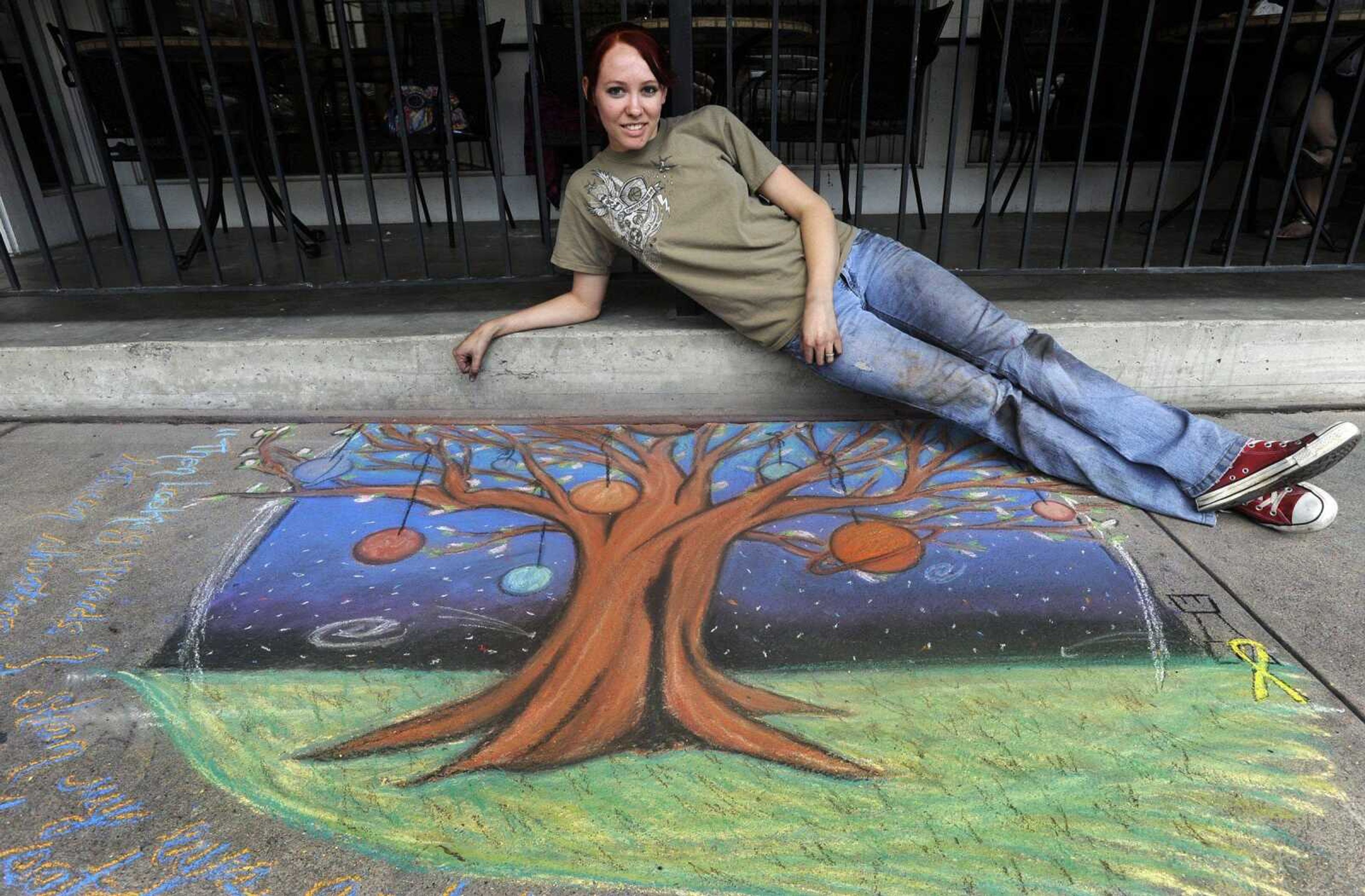 Alisha Castleman-Walter and her chalk art on Main Street. (FRED LYNCH ~ flynch@semissourian.com\)