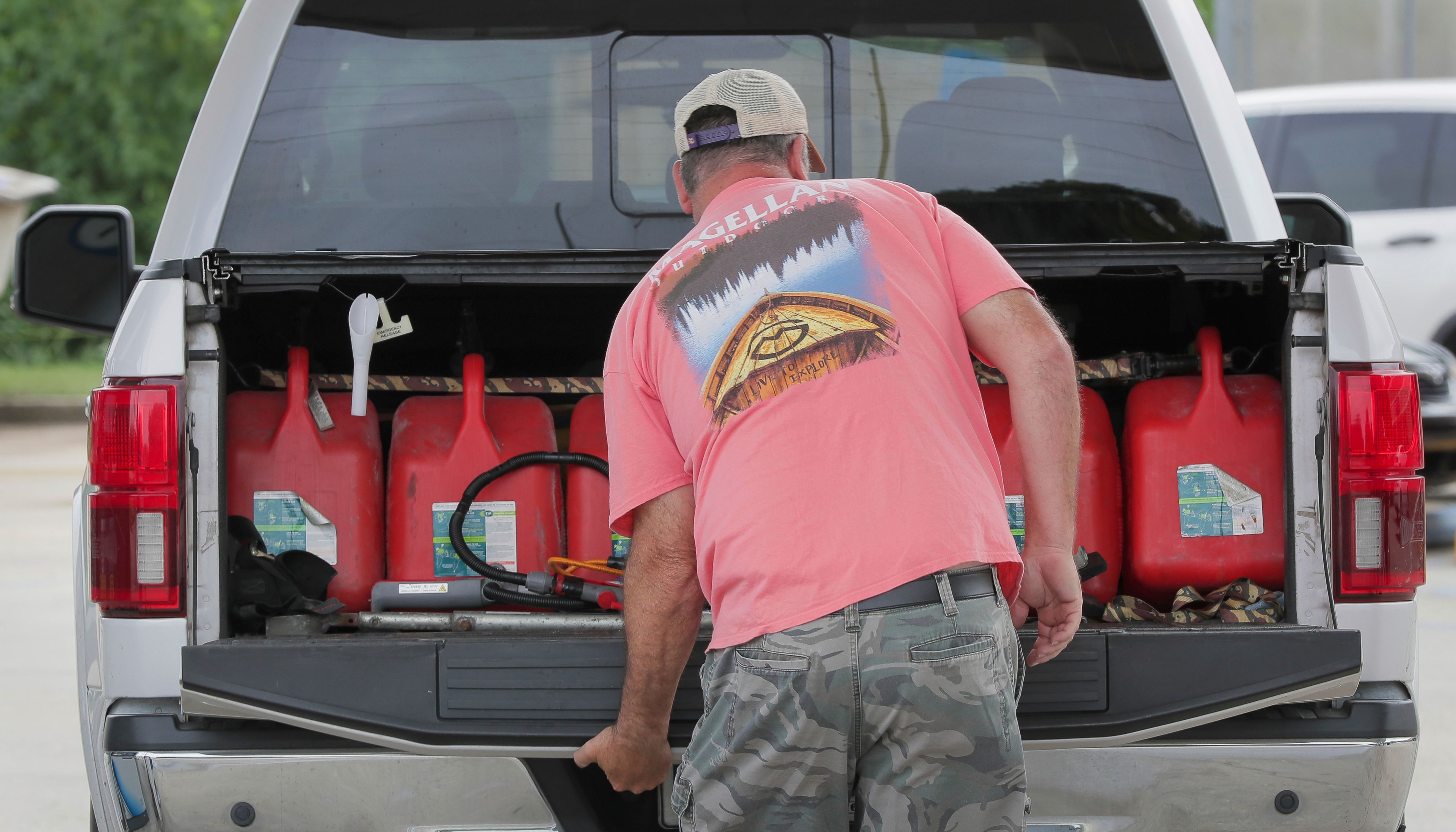 Steve Pete filled up gas containers to give to neighbors and the elderly if they need it ahead of Tropical Storm Francine in Violet, La. Monday, Sept. 9, 2024. (David Grunfeld/The Times-Picayune/The New Orleans Advocate via AP)