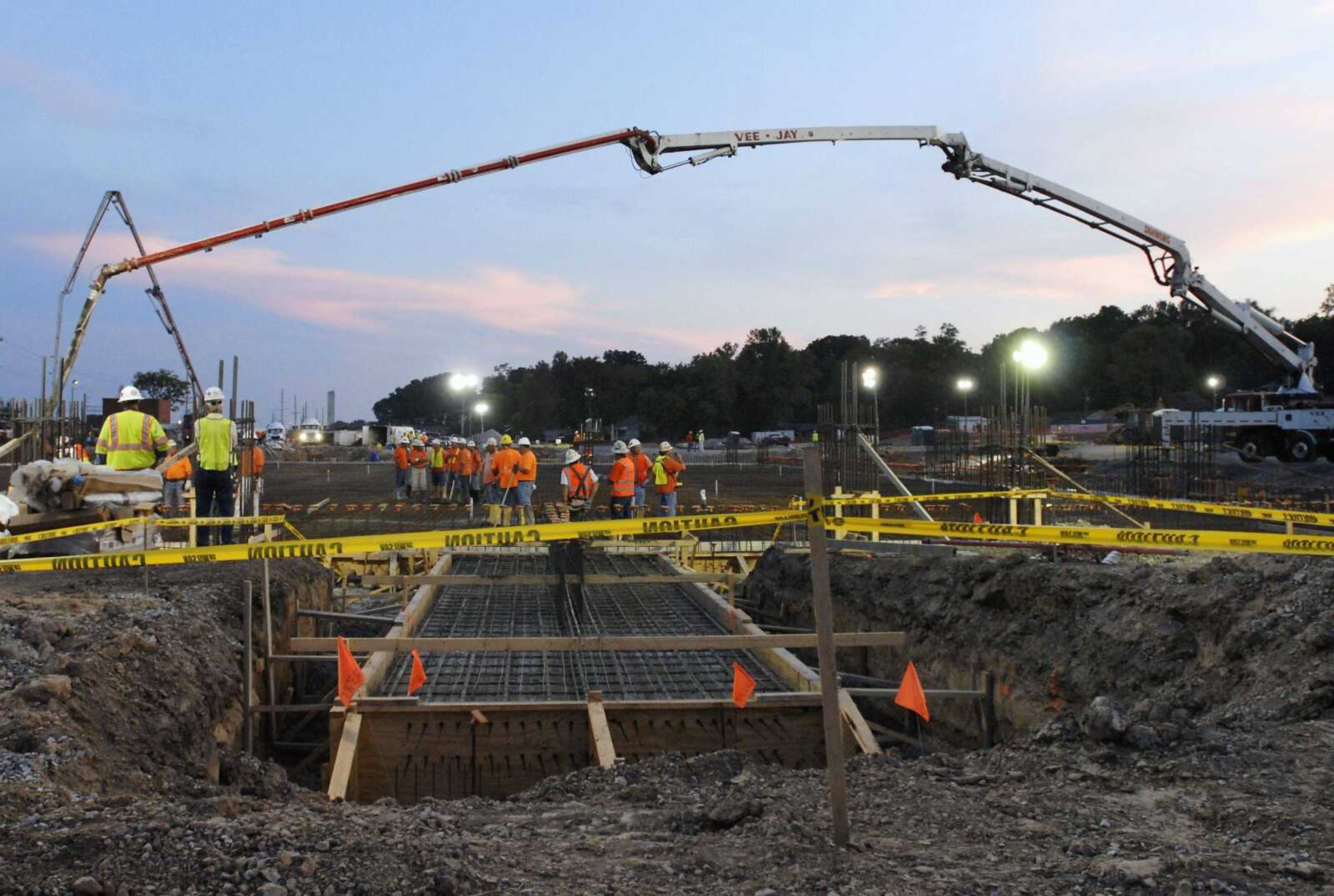 Workers at the Isle of Capri casino site begin pouring the concrete for the basin that will hold the floating casino floor Tuesday. Work continued throughout the night and required concrete from 40 trucks per hour, totaling 2,100 cubic yards of concrete. (Kristin Eberts)