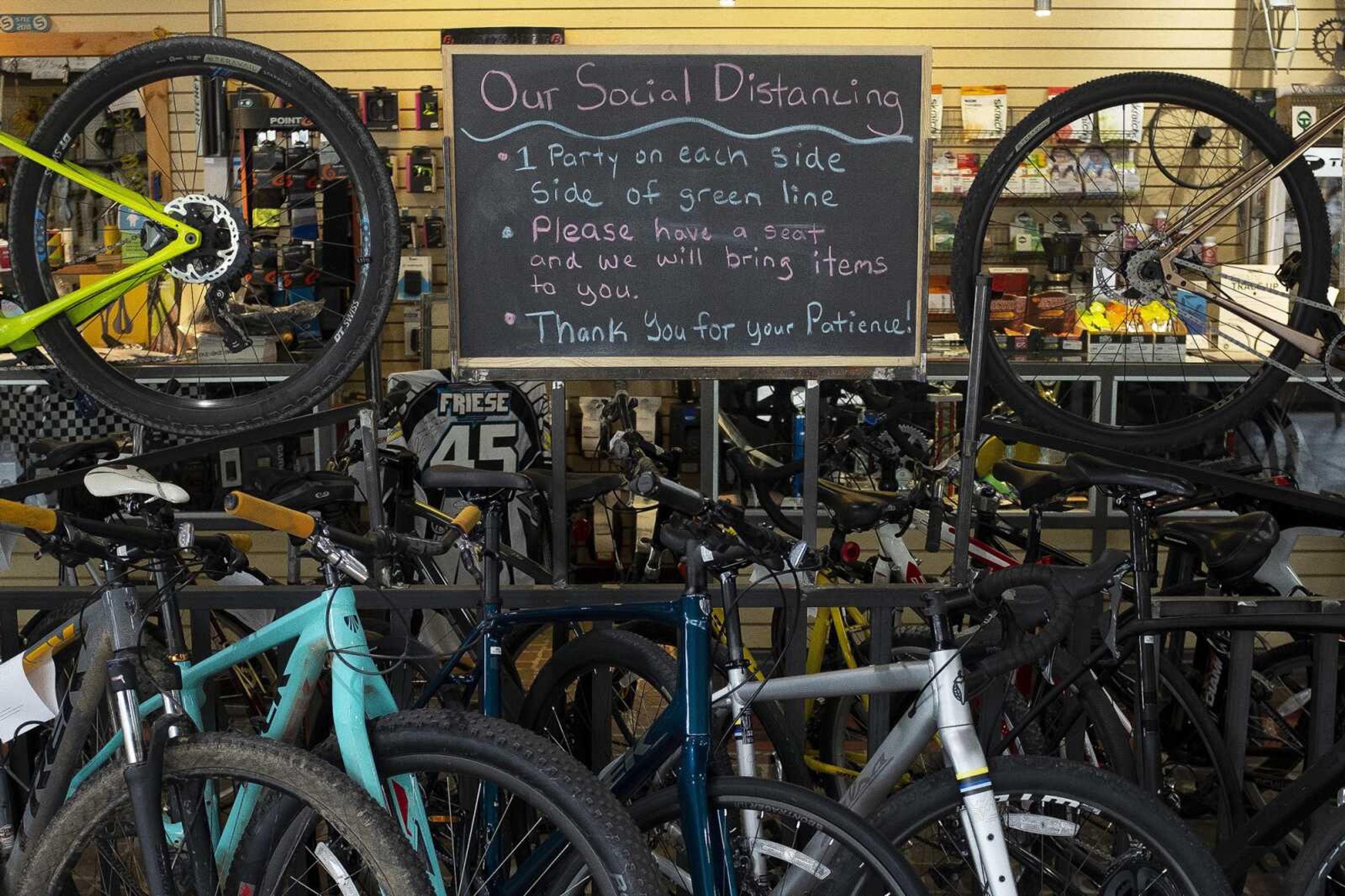 A sign with social-distancing instructions is seen Thursday at CYCLEWERX in Cape Girardeau.