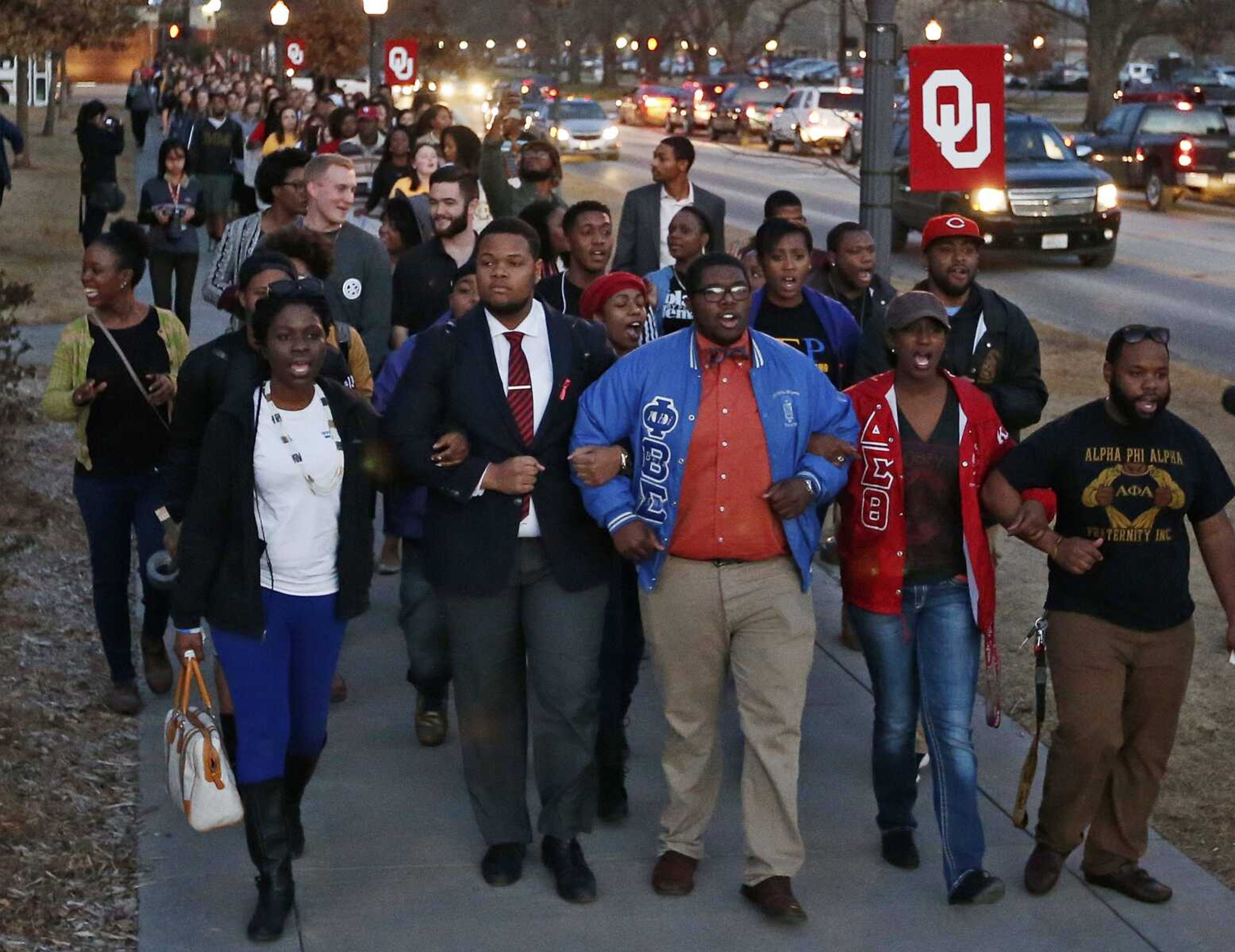 University of Oklahoma students march to the now-closed University of Oklahoma's Sigma Alpha Epsilon fraternity house Tuesday in Norman, Oklahoma, during a rally in reaction to an incident in which members of a fraternity were caught on video chanting a racial slur. (Sue Ogrocki ~ Associated Press)