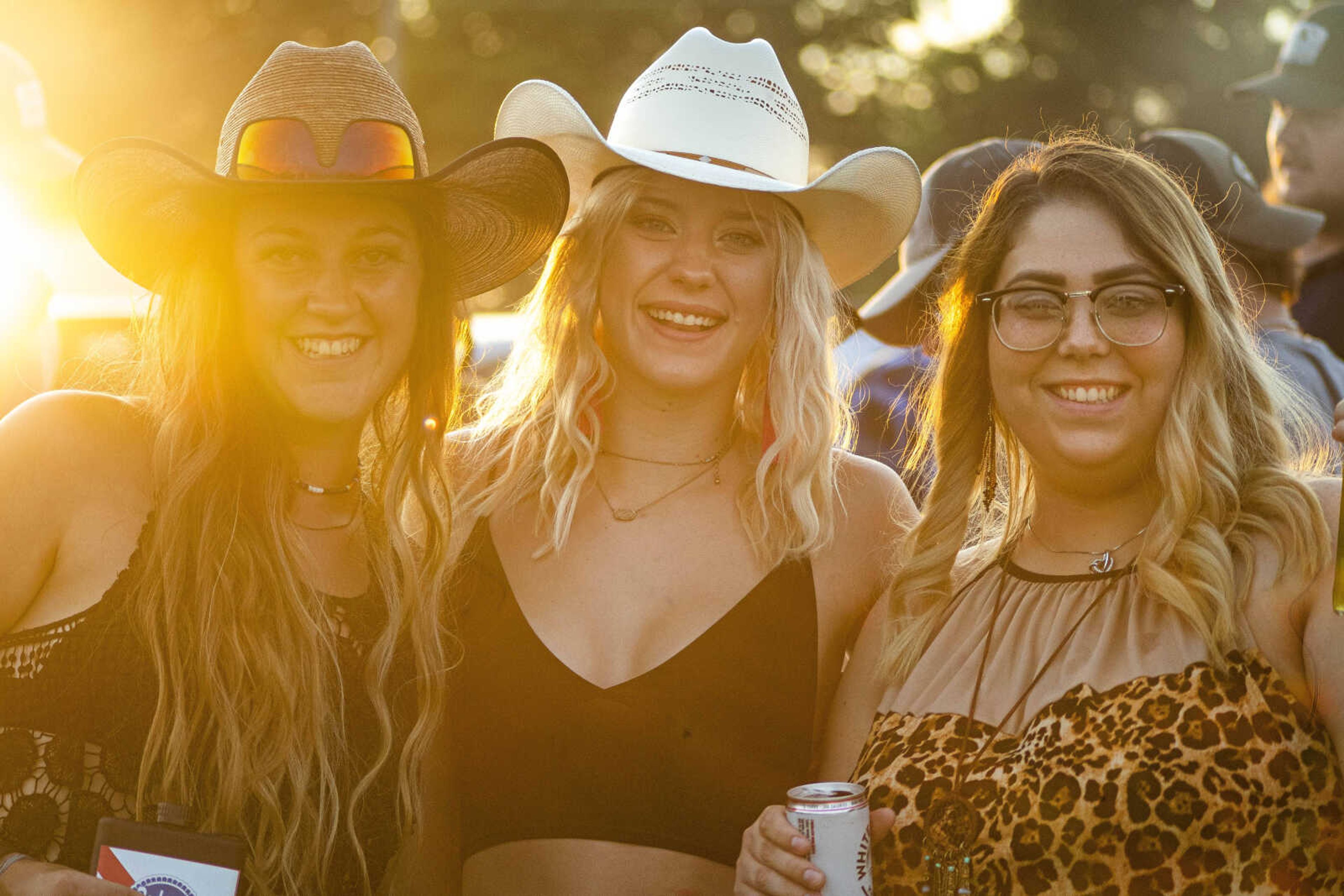 From left, Brooke Gardner, Elise Werk, and Chloe Reeves smile for a portrait while tailgating during the last night of the Sikeston Jaycee Bootheel Rodeo Saturday, Aug. 14, 2021,&nbsp;in Sikeston, Missouri.