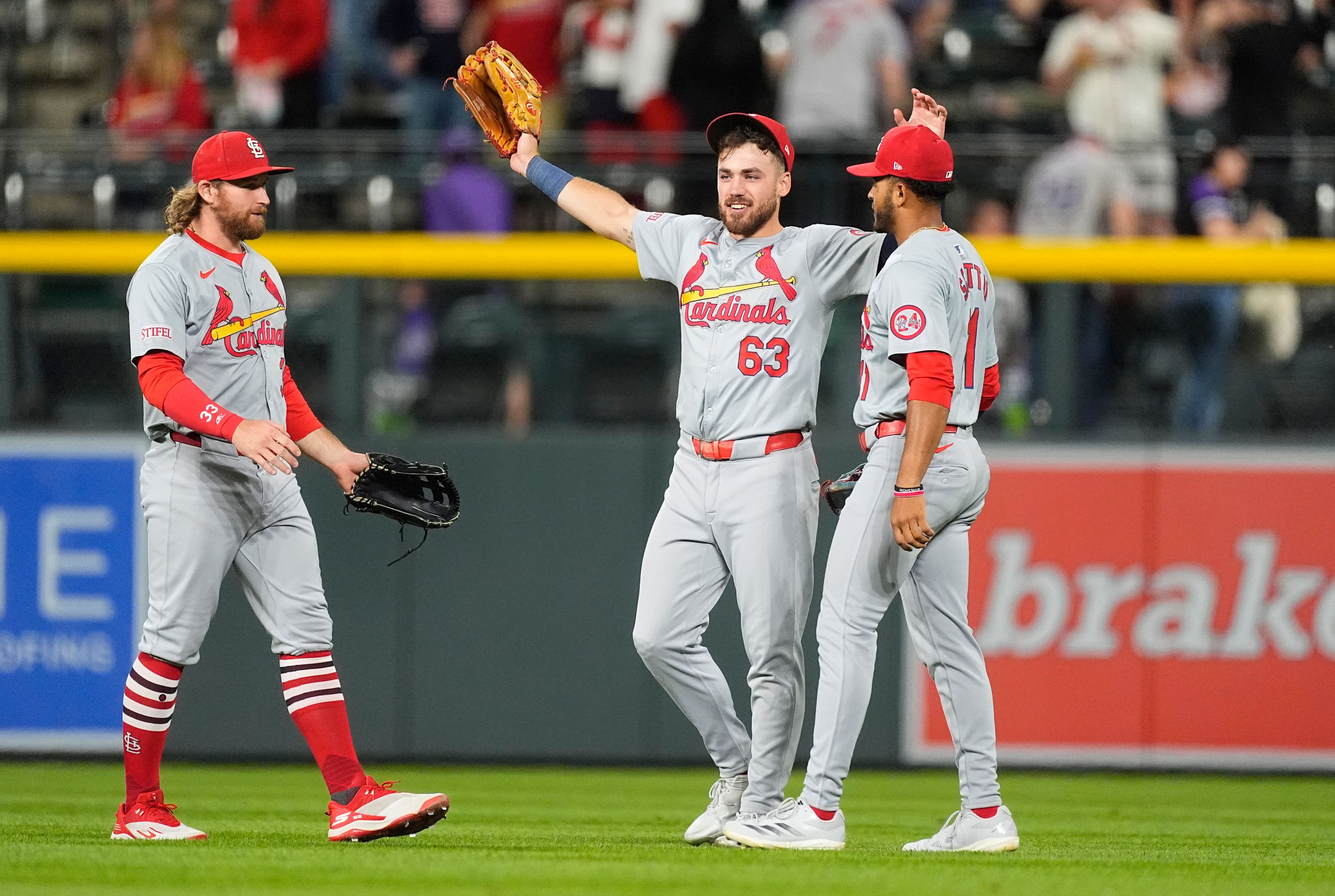 From left, St. Louis Cardinals left fielder Brandon Donovan joins center fielder Michael Siani and right fielder Victor Scott II in celebration after deafeating the Colorado Rockies in a baseball game Wednesday, Sept. 25, 2024, in Denver. (AP Photo/David Zalubowski)