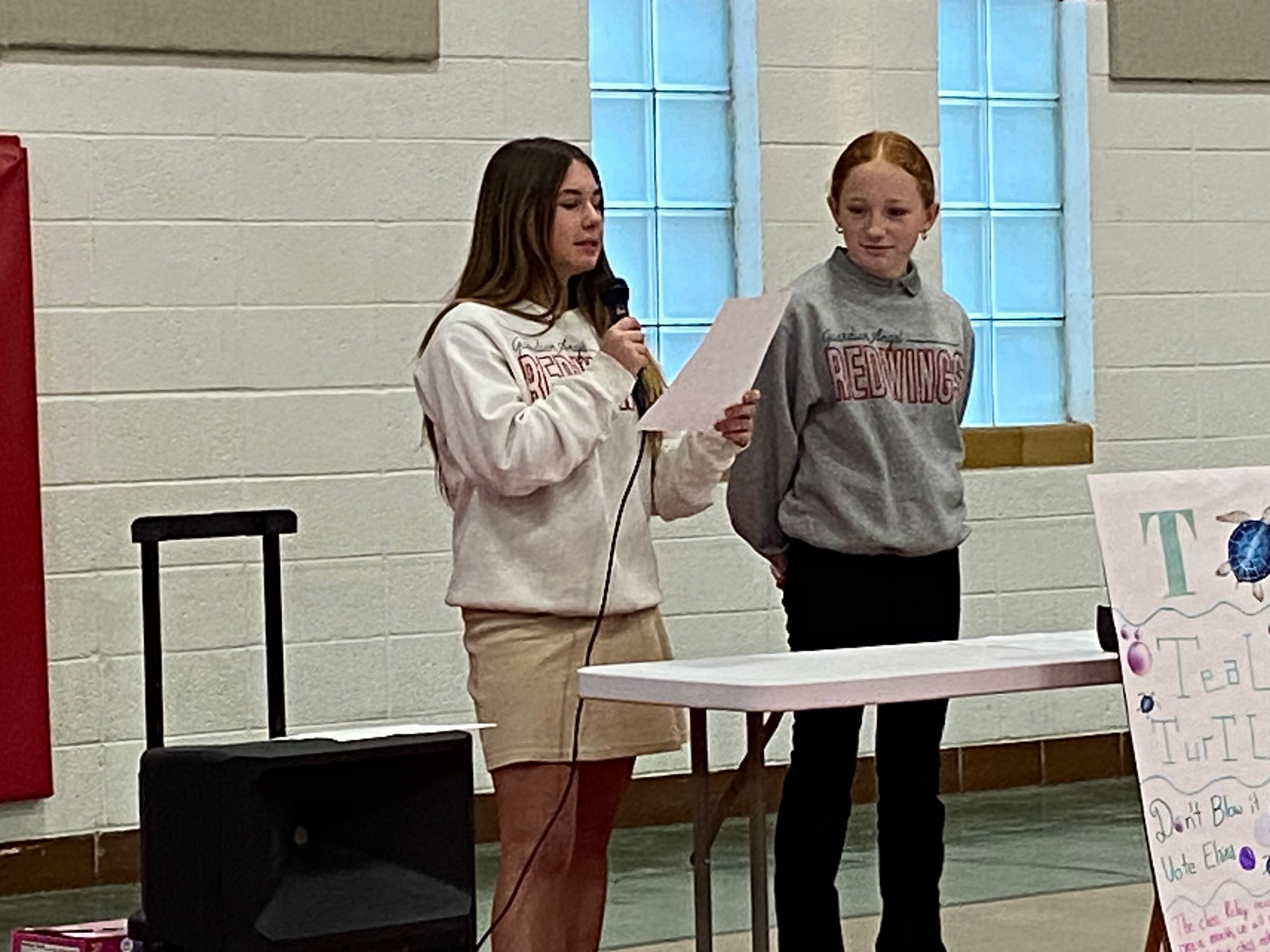 Elaina Hahn, presidential candidate for "Teal Turtles", gives her answer to the debate question as Ashtyn Pobst, her vice presidential running mate stands by her.