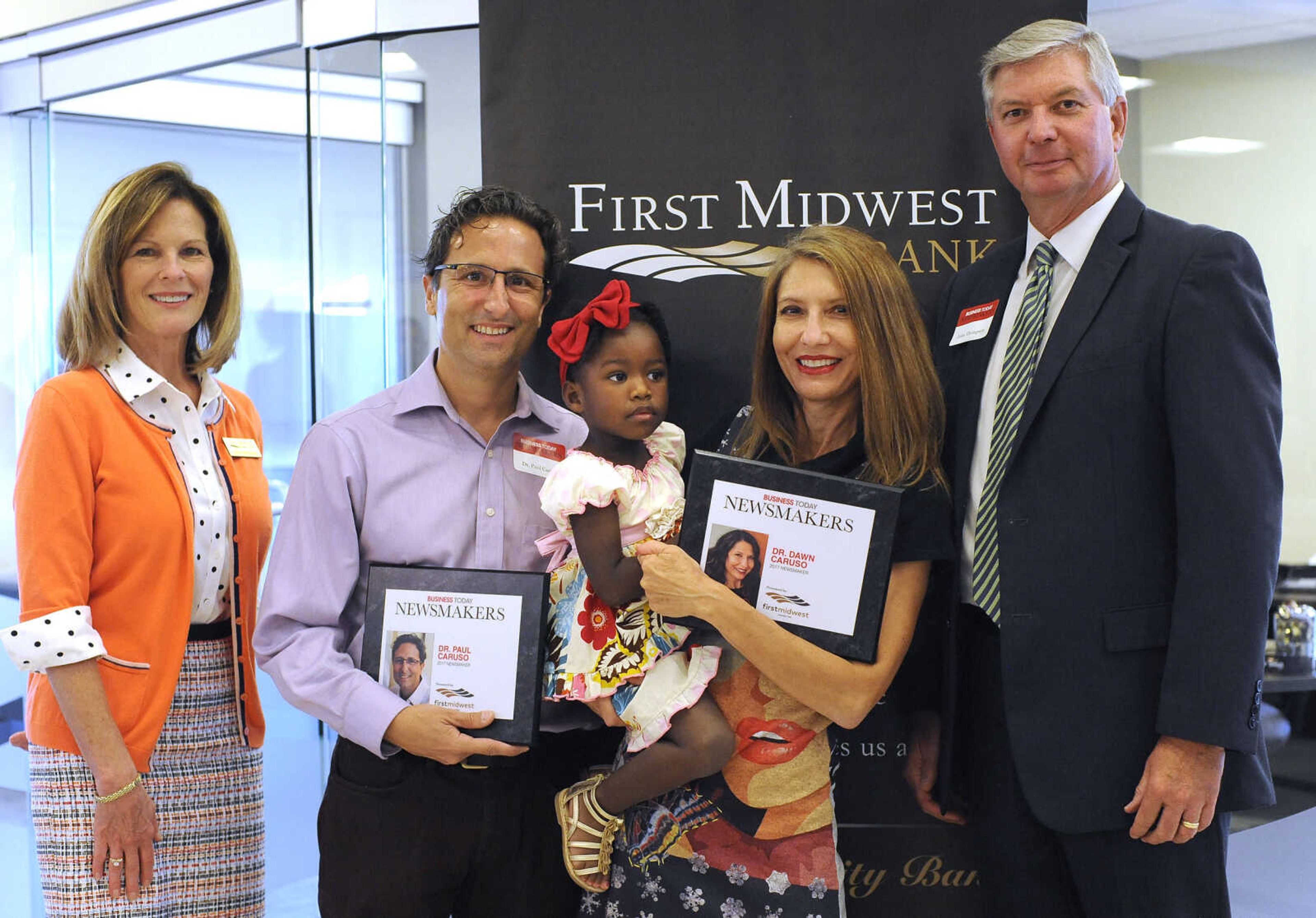 FRED LYNCH ~ flynch@semissourian.com
Dr. Paul Caruso and Dr. Dawn Caruso, holding Iris, pose for a photo with Kathy Bertrand, First Midwest Bank community bank president, Cape Girardeau, and John N. Thompson, First Midwest Bank community bank president, Jackson, Wednesday, Sept. 6, 2017 during the Business Today Newsmakers awards reception at First Midwest Bank in Cape Girardeau.