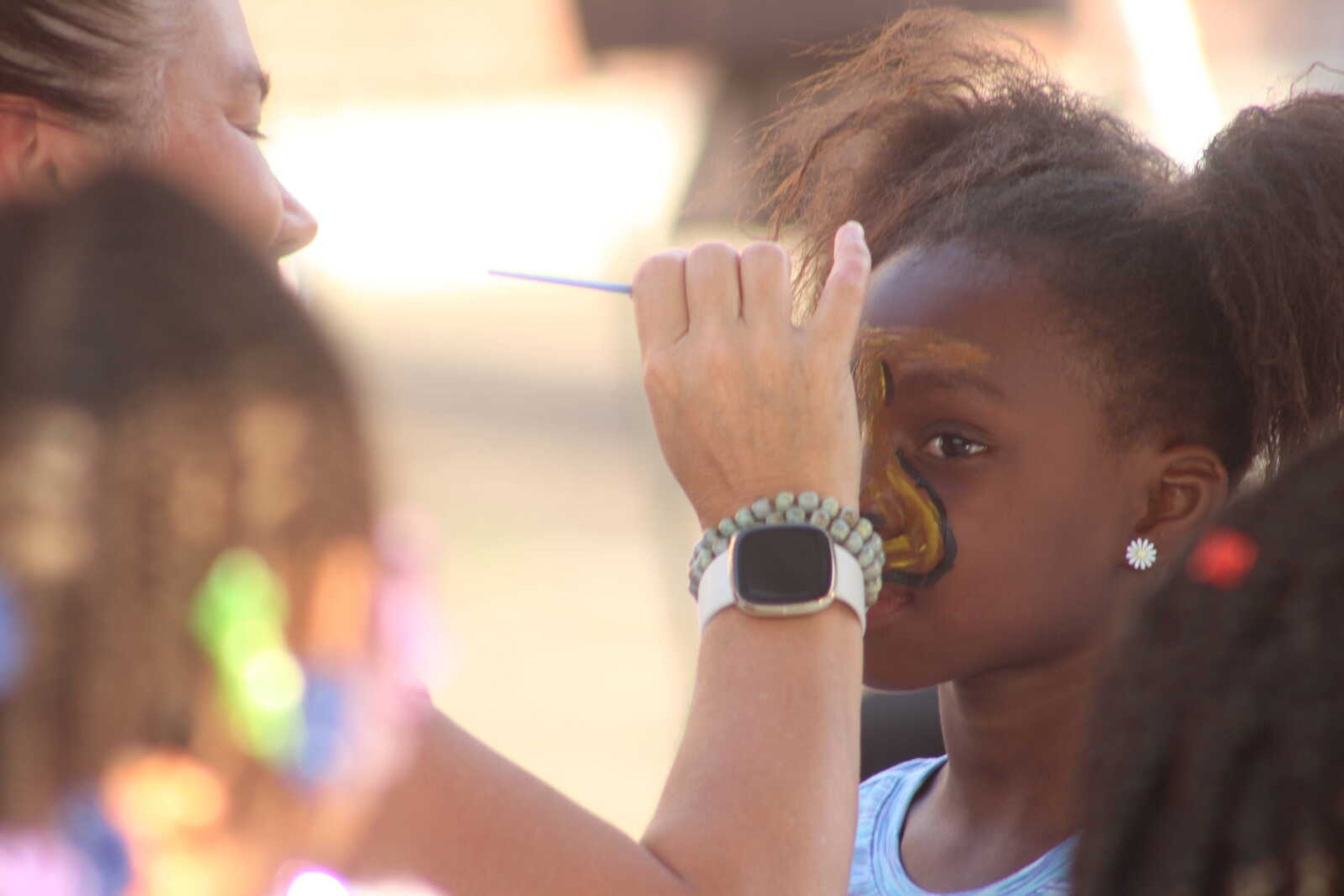 Lera Ferguson, 8, gets her face painted to look like a lion at One City's second annual Juneteenth Celebration on Saturday, June 19, 2021, in the parking lot of One City in Cape Girardeau.