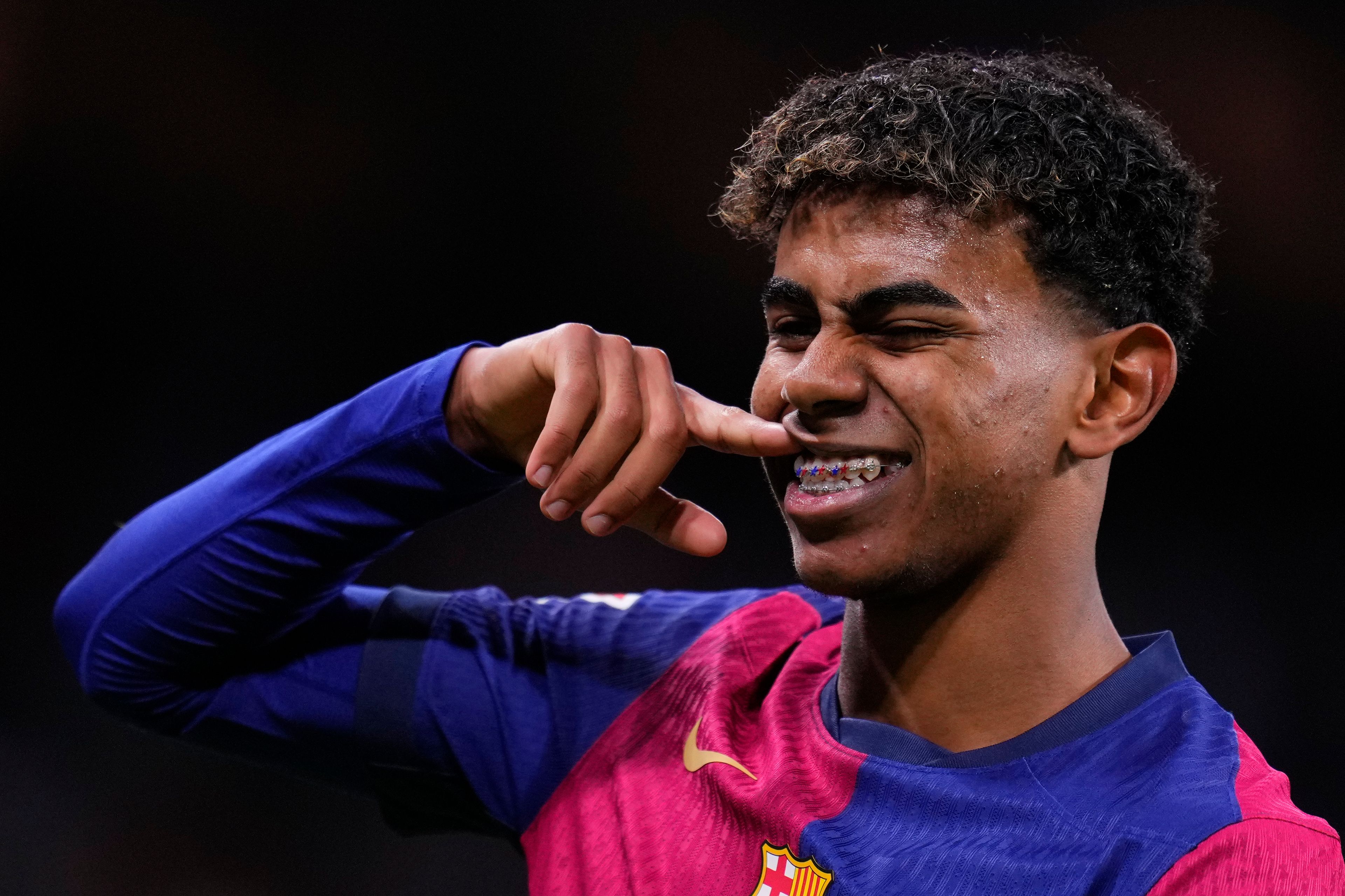 Barcelona's Lamine Yamal celebrates after scoring his side's third goal during the Spanish La Liga soccer match between Real Madrid and Barcelona at the Santiago Bernabeu stadium in Madrid, Spain, Saturday, Oct. 26, 2024. (AP Photo/Manu Fernandez)