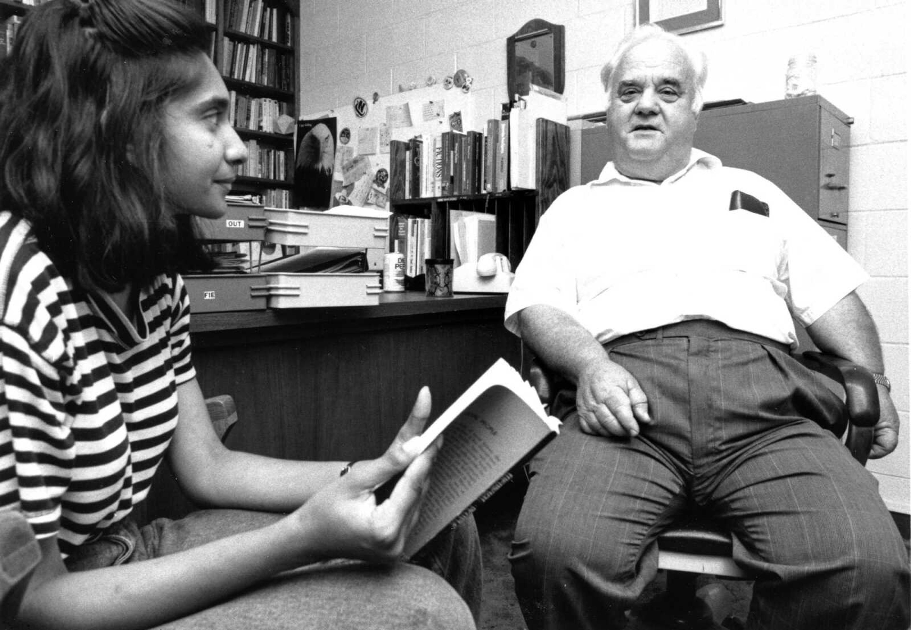 Published May 14, 1991.
Peter Hilty, professor of English at Southeast Missouri State University, talked with student Therese Gunawardena from Sri Lanka in his office in the Grauel Building. Hilty, who had taught at Southeast for 29 years, was one of 14 university faculty who retired that year. (Southeast Missouri archive)