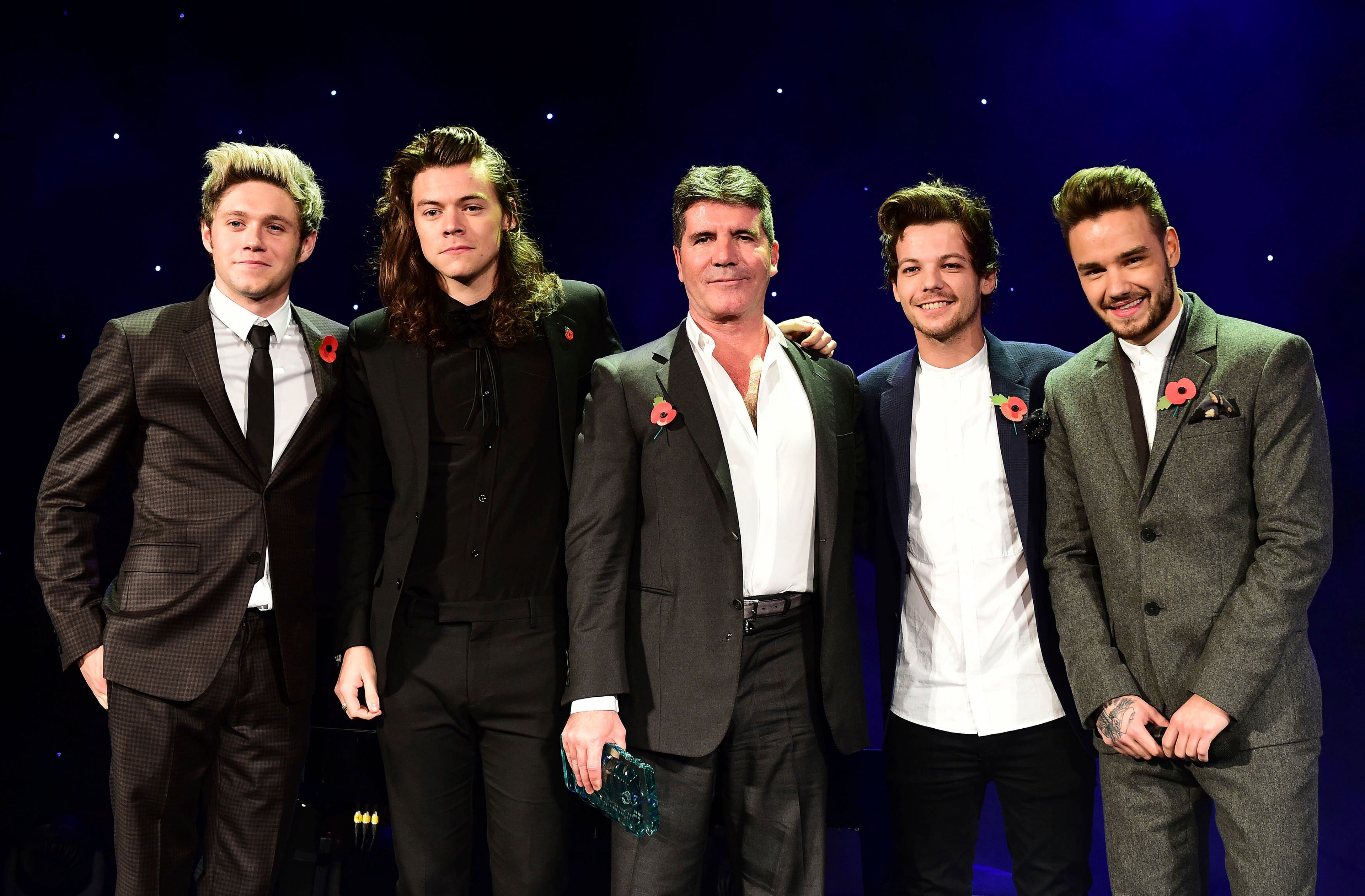 FILE - One Direction's Niall Horan, from left, Harry Styles , Simon Cowell, Louis Tomlinson and Liam Payne present the Music Industry Trust Award to Simon Cowell at the Music Industry Trusts Award (MITS) in aid of charities Nordon Robbins and Brit Trust at the Grosvenor House Hotel, in London, Nov. 2, 2015. (Dominic Lipinski/PA via AP)