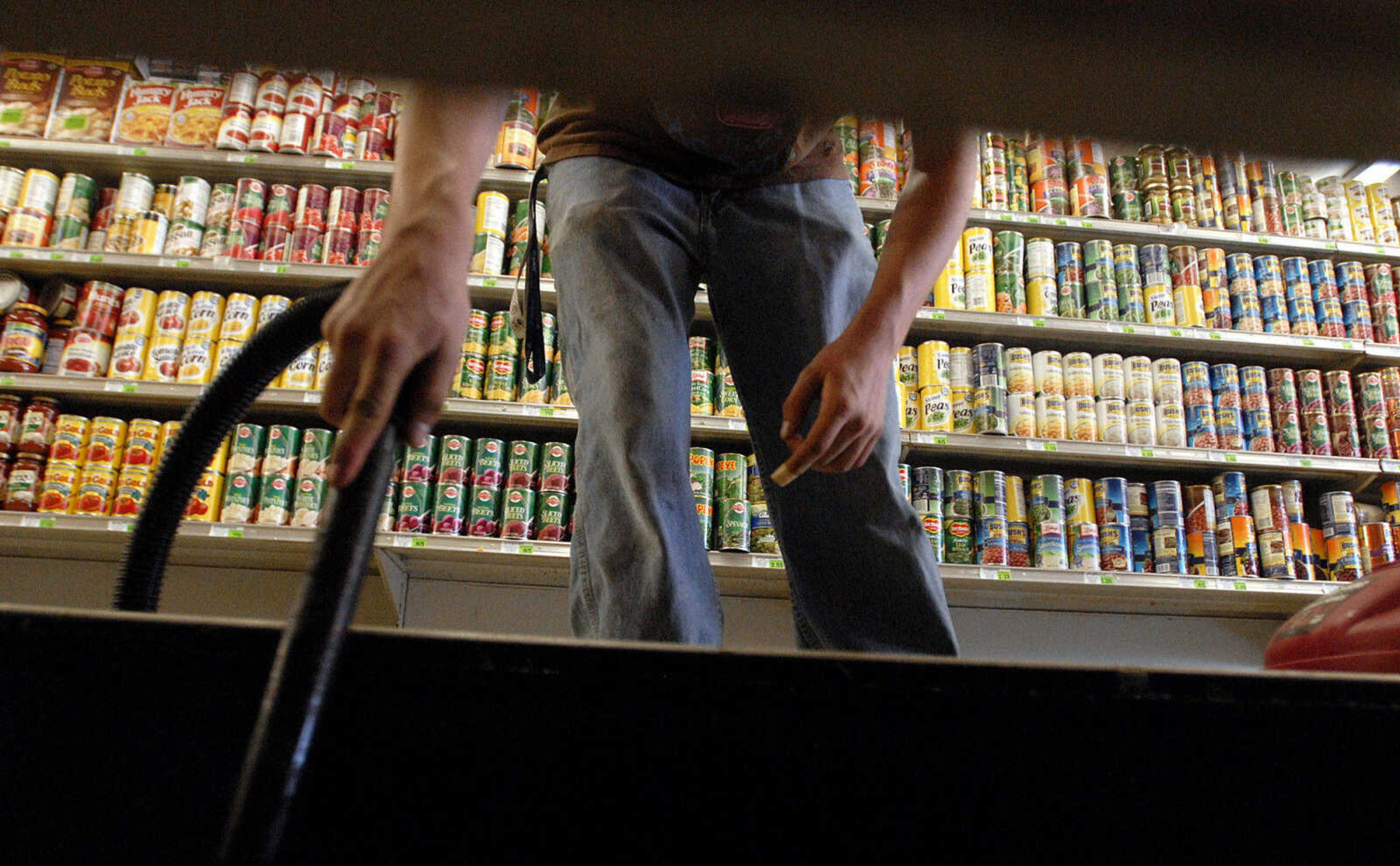 LAURA SIMON~lsimon@semissourian.com
Foodtown employee Travis Poole cleans the bottom shelves in the Olive Branch, Ill. grocery store Thursday, May 5, 2011. The store had 16 inches of water inside when floodwaters were at their highest.