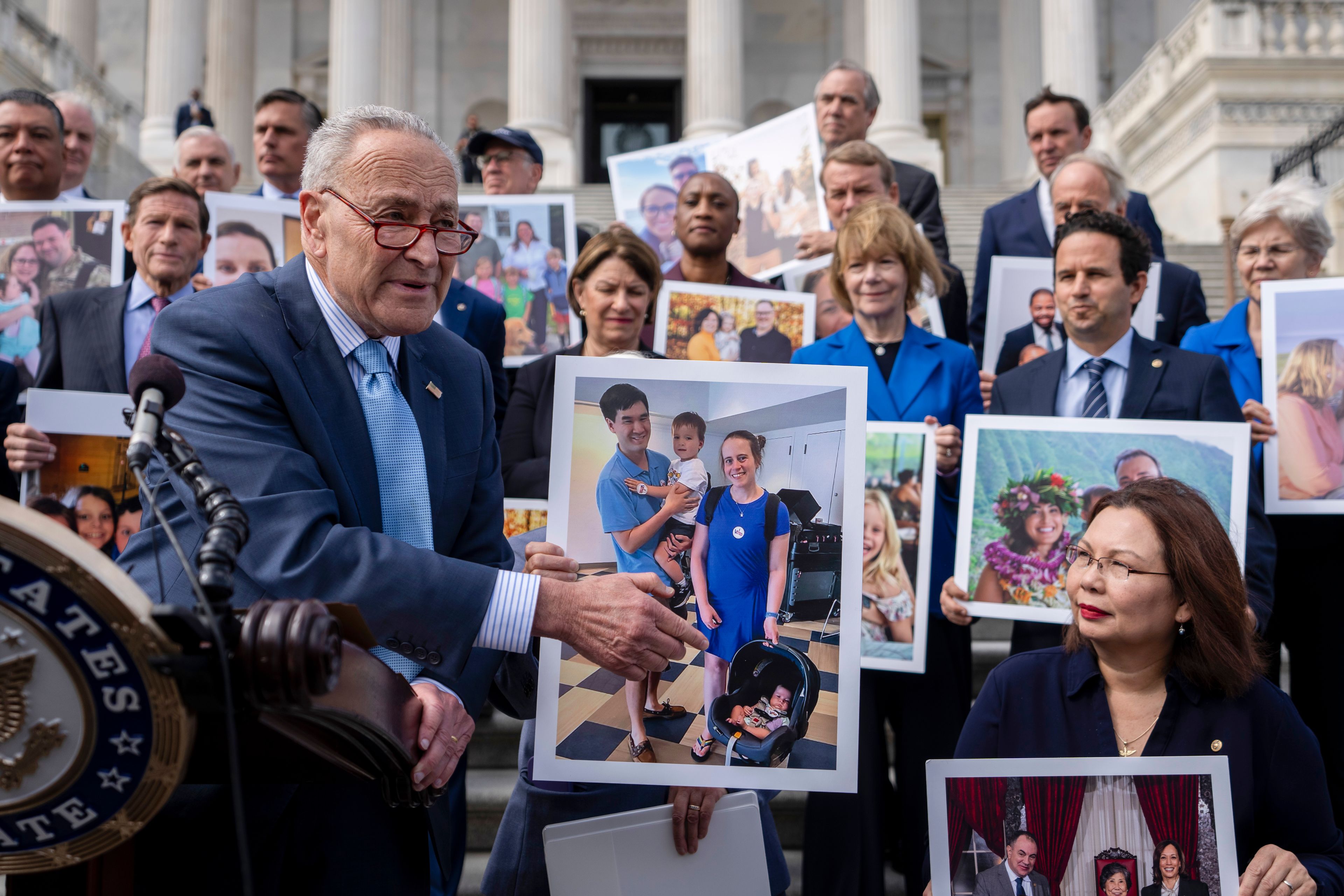 Senate Majority Leader Chuck Schumer, D-NY, left, accompanied by Sen. Tammy Duckworth, D-Ill., right, speaks about the need to protect rights to in vitro fertilization (IVF), on the Senate steps at the Capitol in Washington, Tuesday, Sept. 17, 2024. (AP Photo/Ben Curtis)