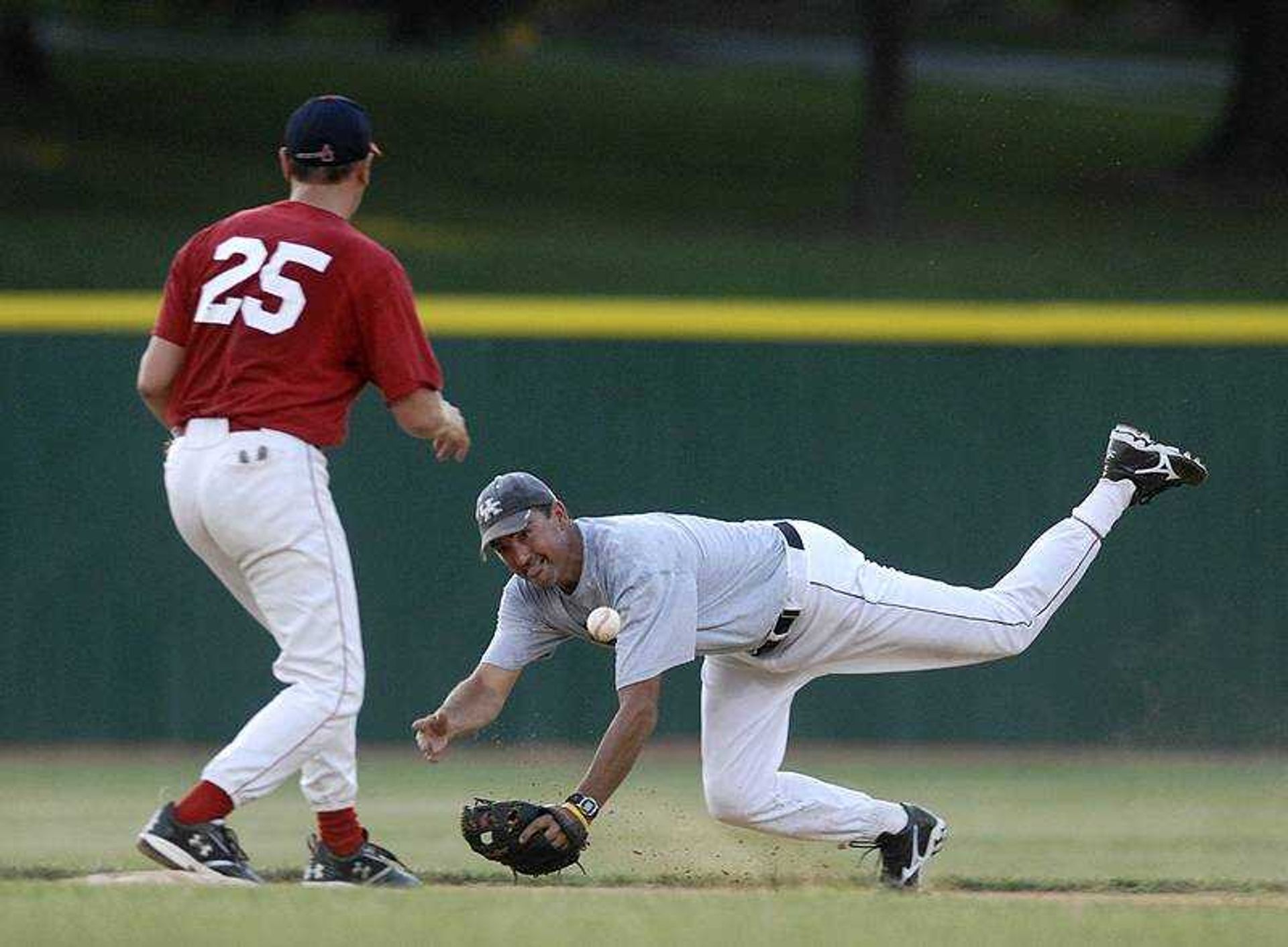 AARON EISENHAUER ~ aeisenhauer@semissourian.com
Second baseman Jeff Bohnert made a diving toss to shortstop Cory Crosnoe as they turned a double play during the Capahas' oldtimers game Saturday at Capaha Field.