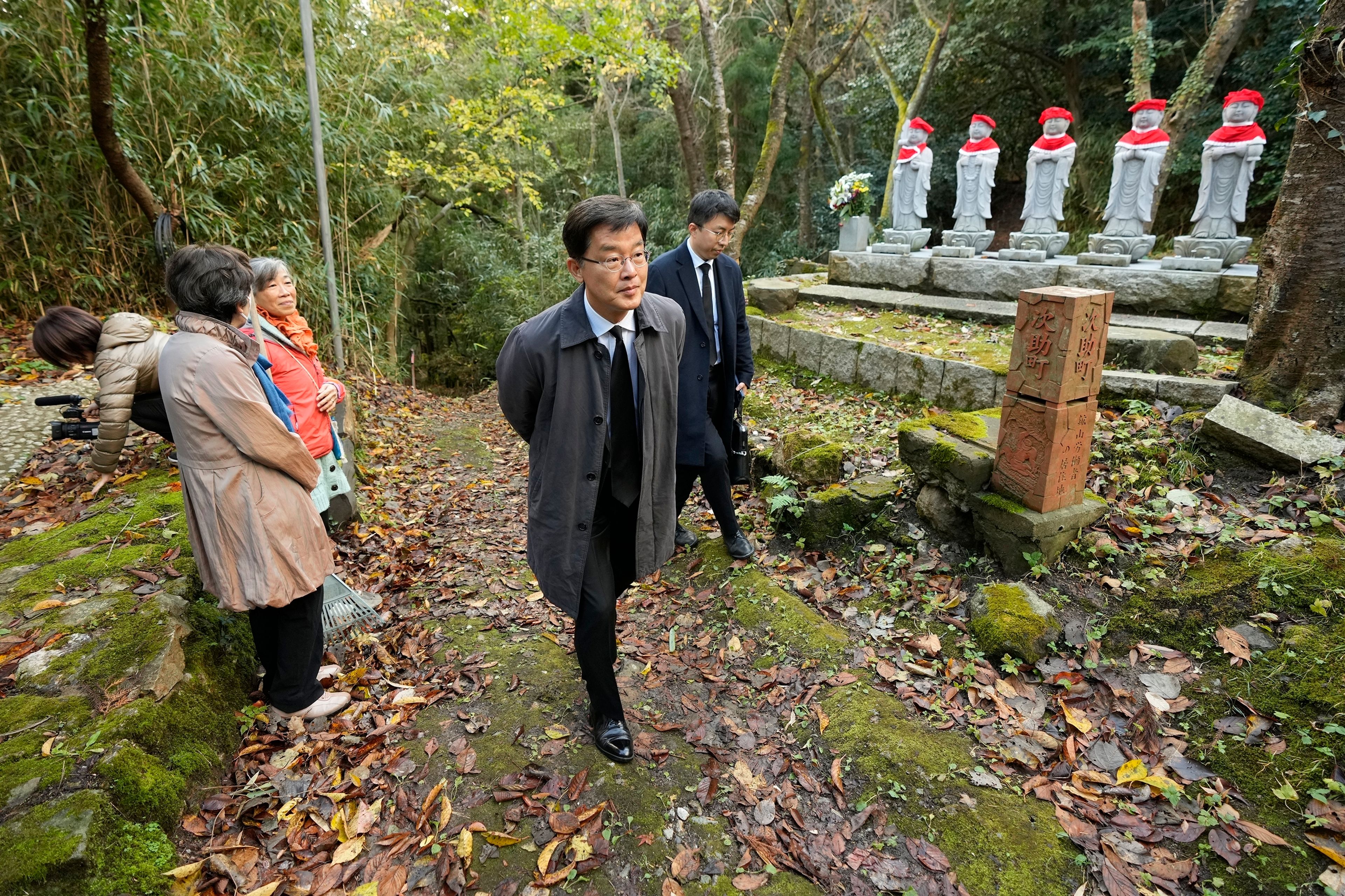 South Korean Ambassador to Japan Park Cheol-hee, center, arrives to join the relatives of Korean victims and South Korean officials to hold a memorial service in Sado, Niigata prefecture, Japan, Monday, Nov. 25, 2024. (AP Photo/Eugene Hoshiko)