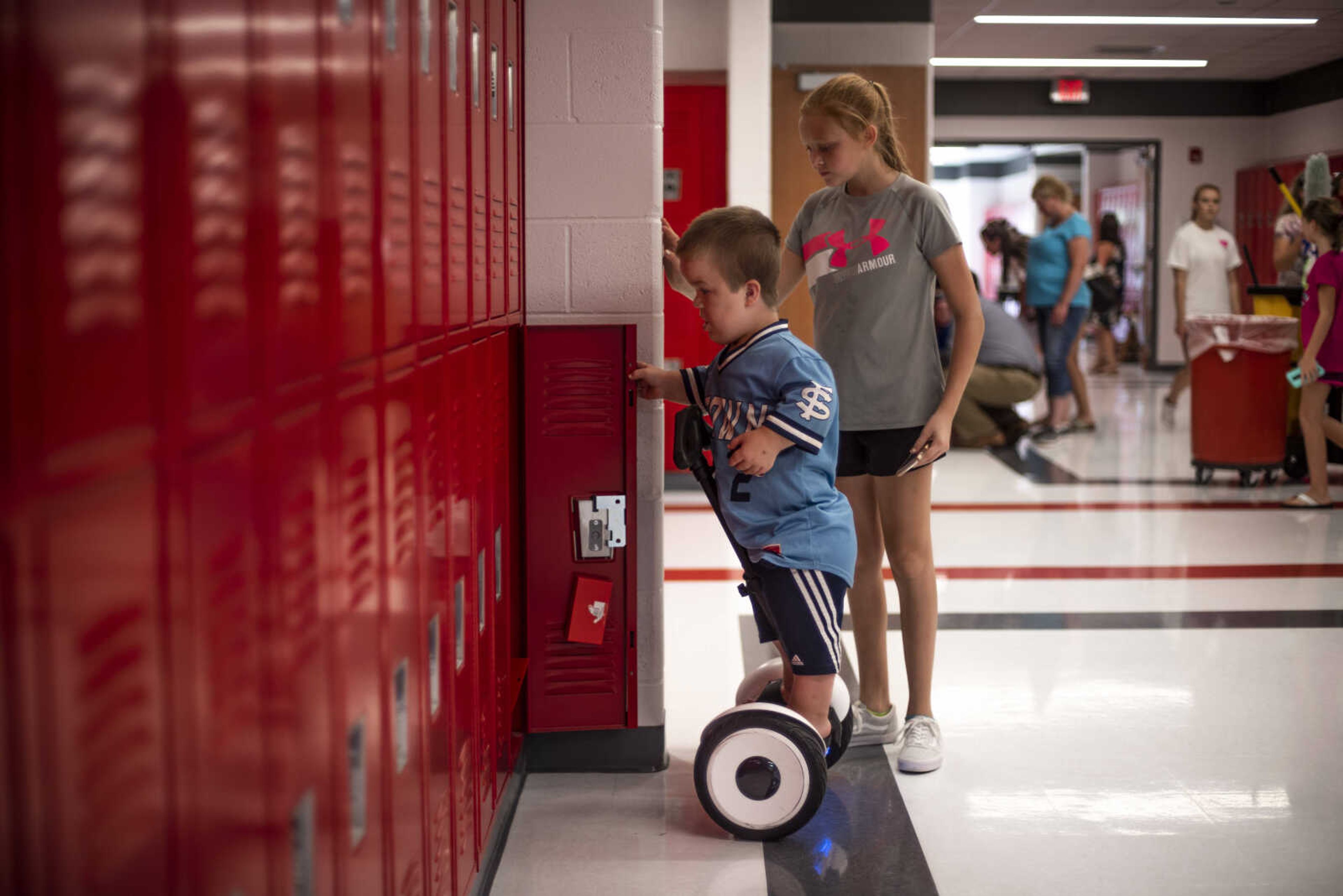 Izaac Pursley shows his big sister Evee-Kay Pursley his new locker at Jackson Middle School during back-to-school night Aug. 30, 2018, in Jackson.