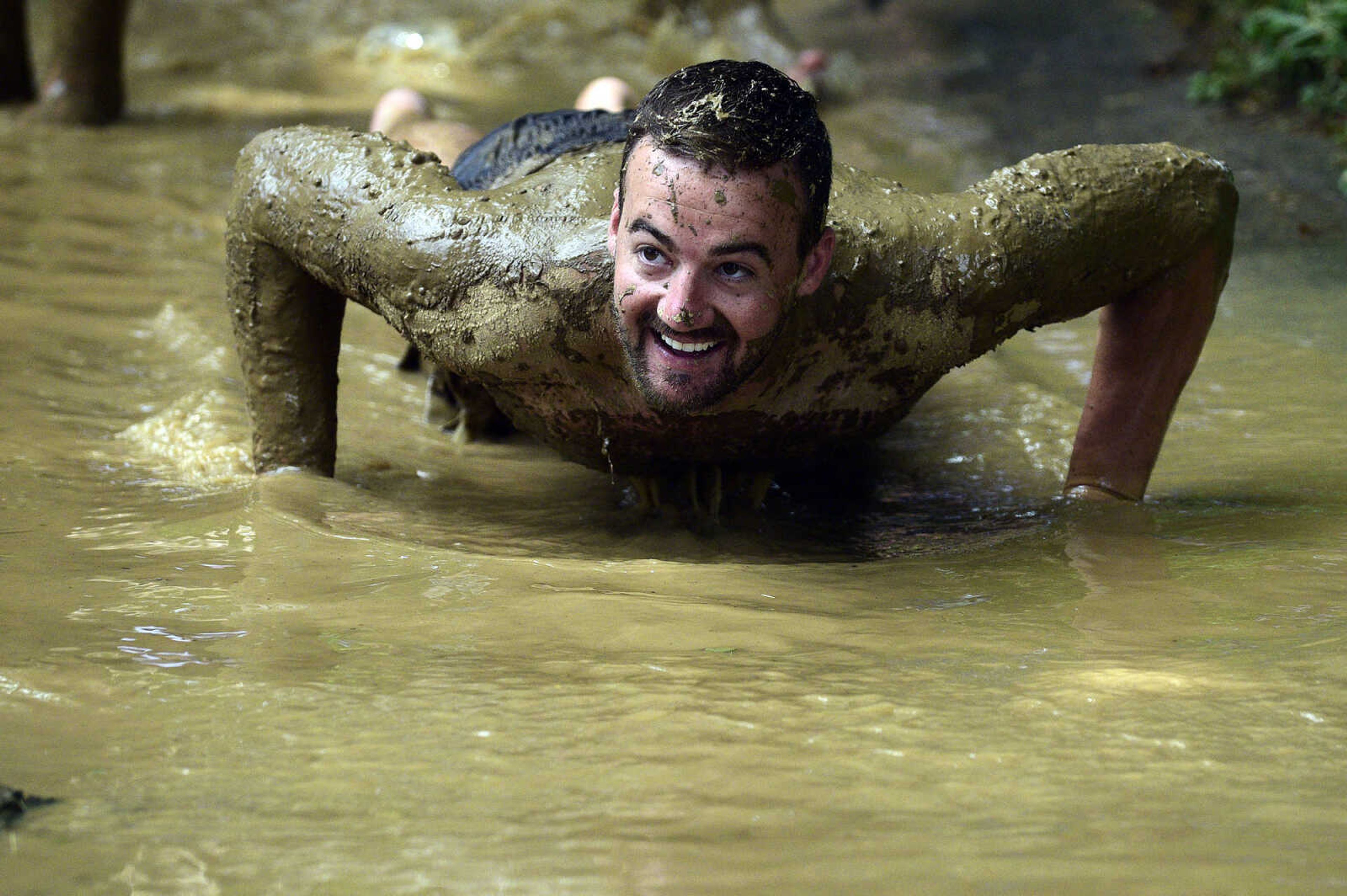 Josh Duncan washes off after playing mud volleyball during the Fourth of July celebration on Tuesday at Jackson City Park.