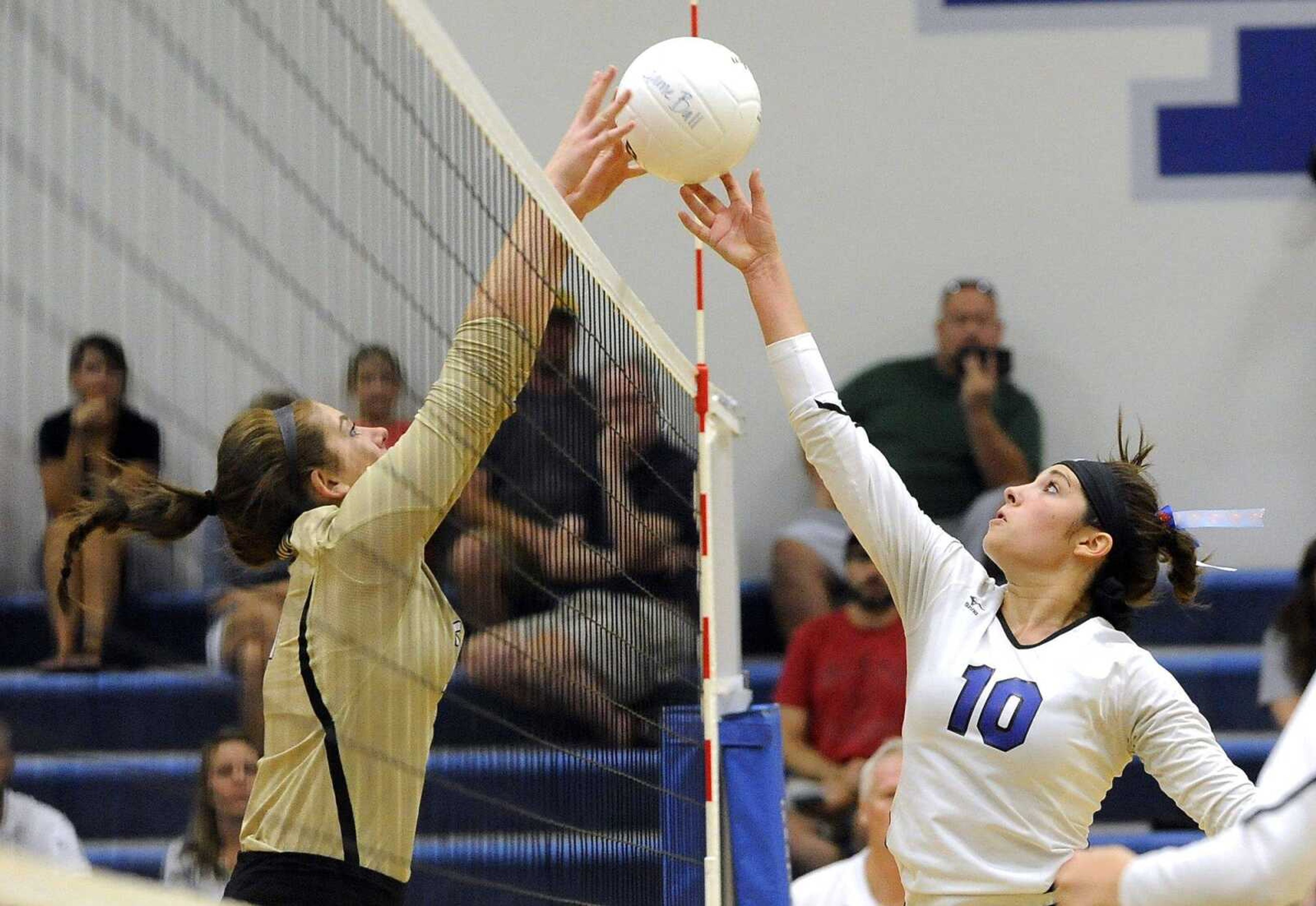 Notre Dame's Sam Brennan attempts a shot that is blocked by Farmington's Jesse Miller during the second set Thursday, Aug. 25, 2016 at Notre Dame Regional High School.