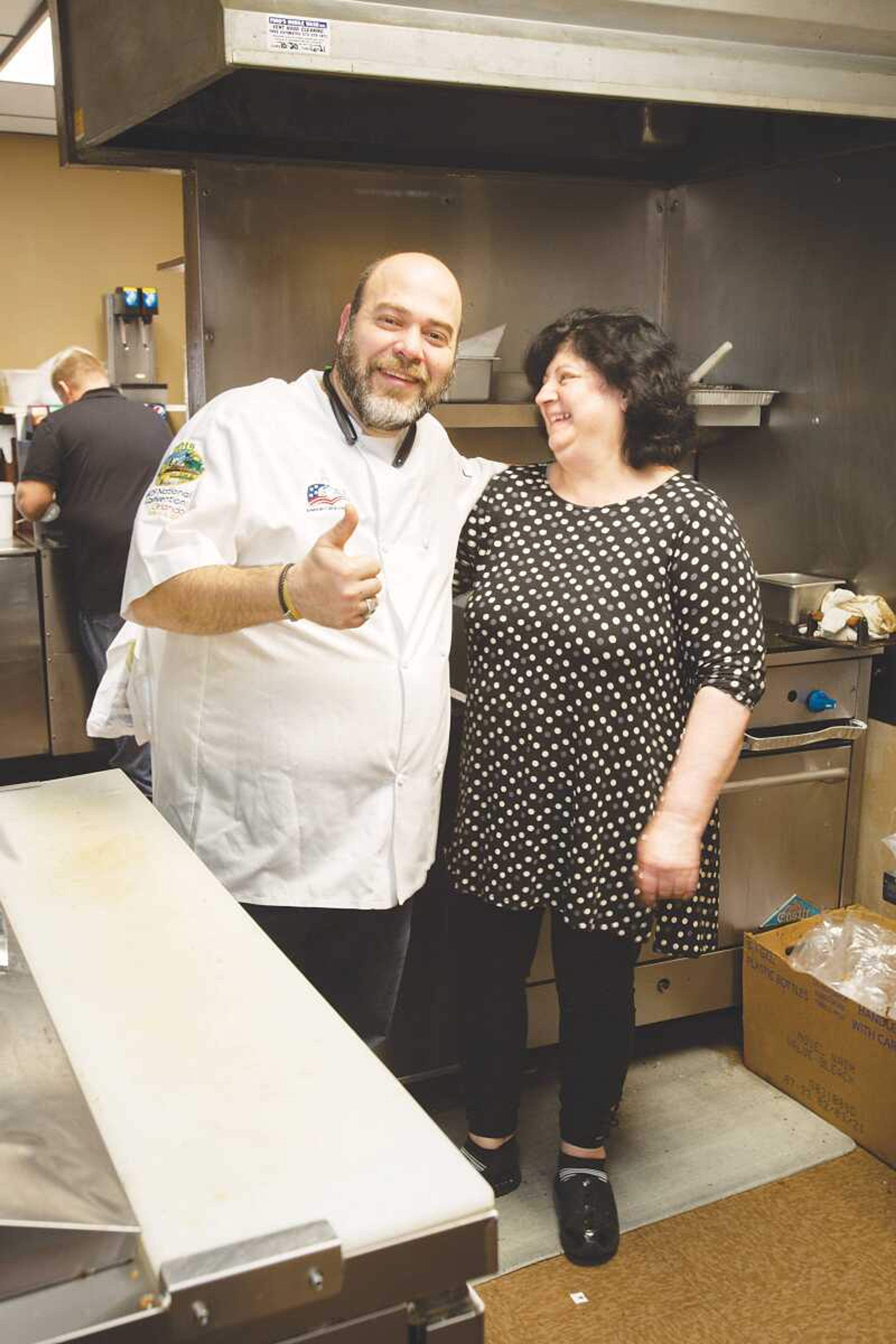 Georgios Kastanias and his aunt Zoi Mousdakos, the founder of Zoi's Gyros Corner, stand for a photo in the kitchen of the restaurant.