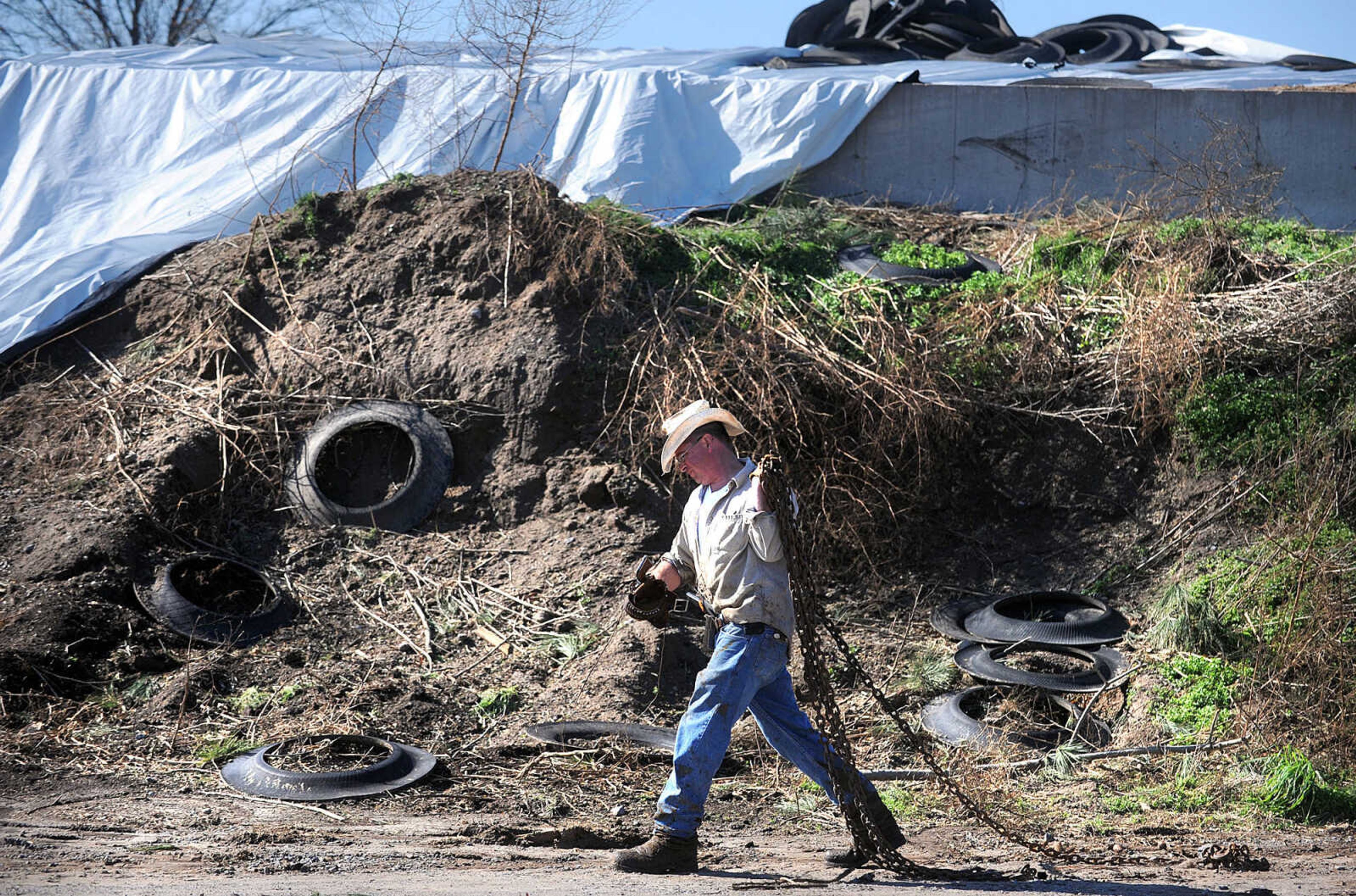 LAURA SIMON ~ lsimon@semissourian.com

David Pellett gathers supplies to take care of a cow with broken legs at Vince Draper's cattle farm, Monday, Nov. 18, 2013. Sunday's storm tore through the cattle farm, causing heavy damage and several cow fatalities.