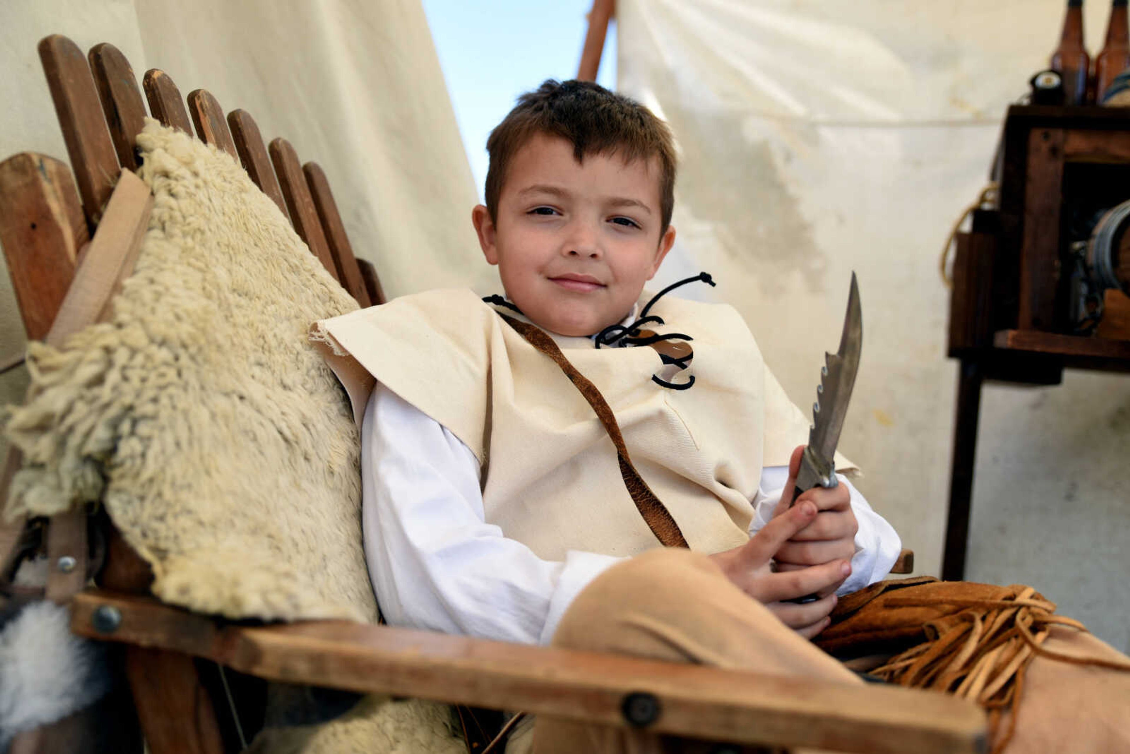 Talon Felty, 8, poses for a portrait with his knife at the second annual Eastern Ozark Rendezvous held at Bark's Planation Saturday, March 17, 2018, in Glenallen.