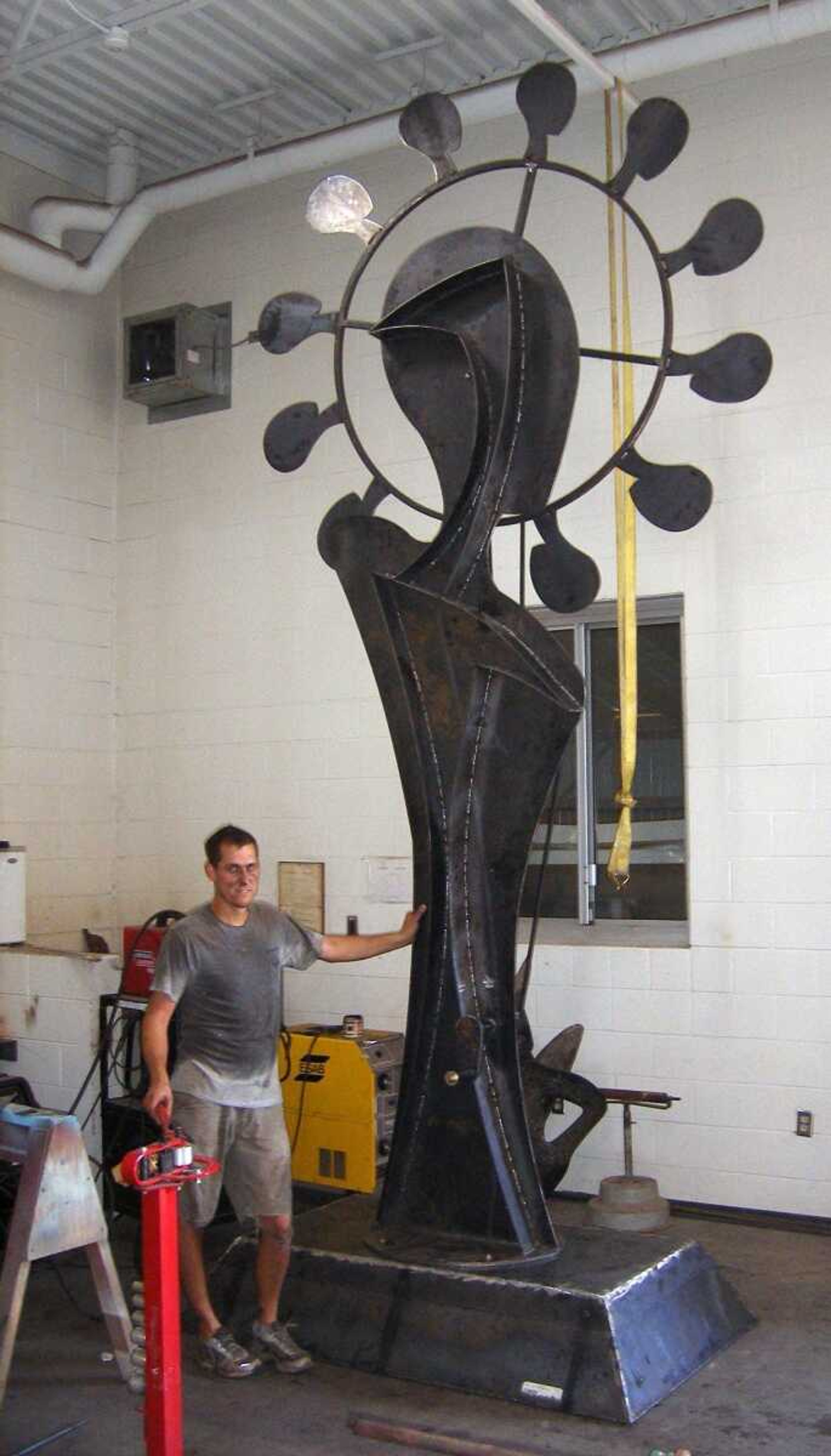 Scott City artist Matt Miller is seen with the 16-foot-tall sculpture he will enter in ArtPrize in Grand Rapids, Mich. (Submitted photo)