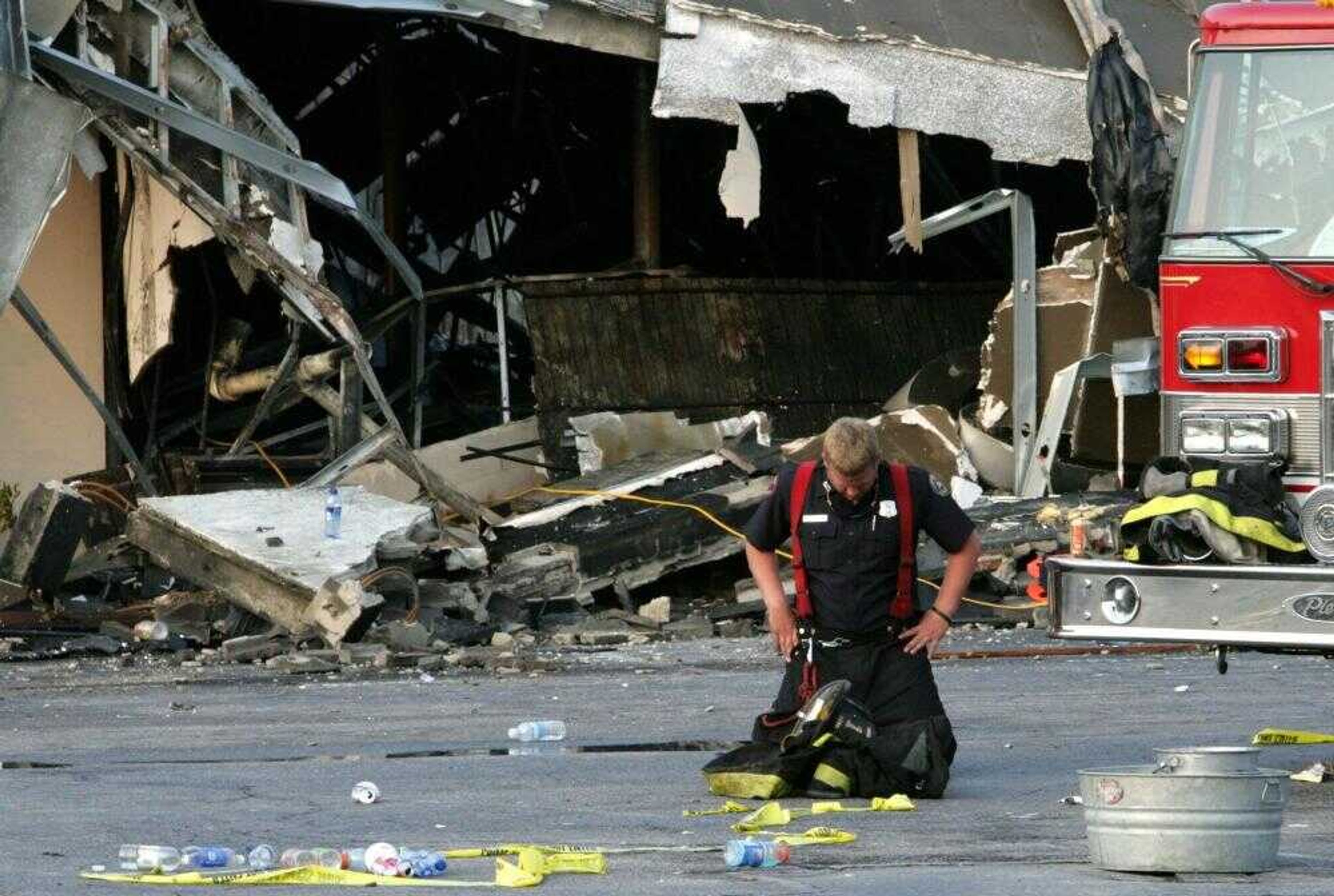 A firefighter took a moment Tuesday after helping to put out the fire that claimed the lives of nine Charleston area firefighters at the Sofa Super Store in Charleston, S.C. (Alice Keeney ~ Associated Press)