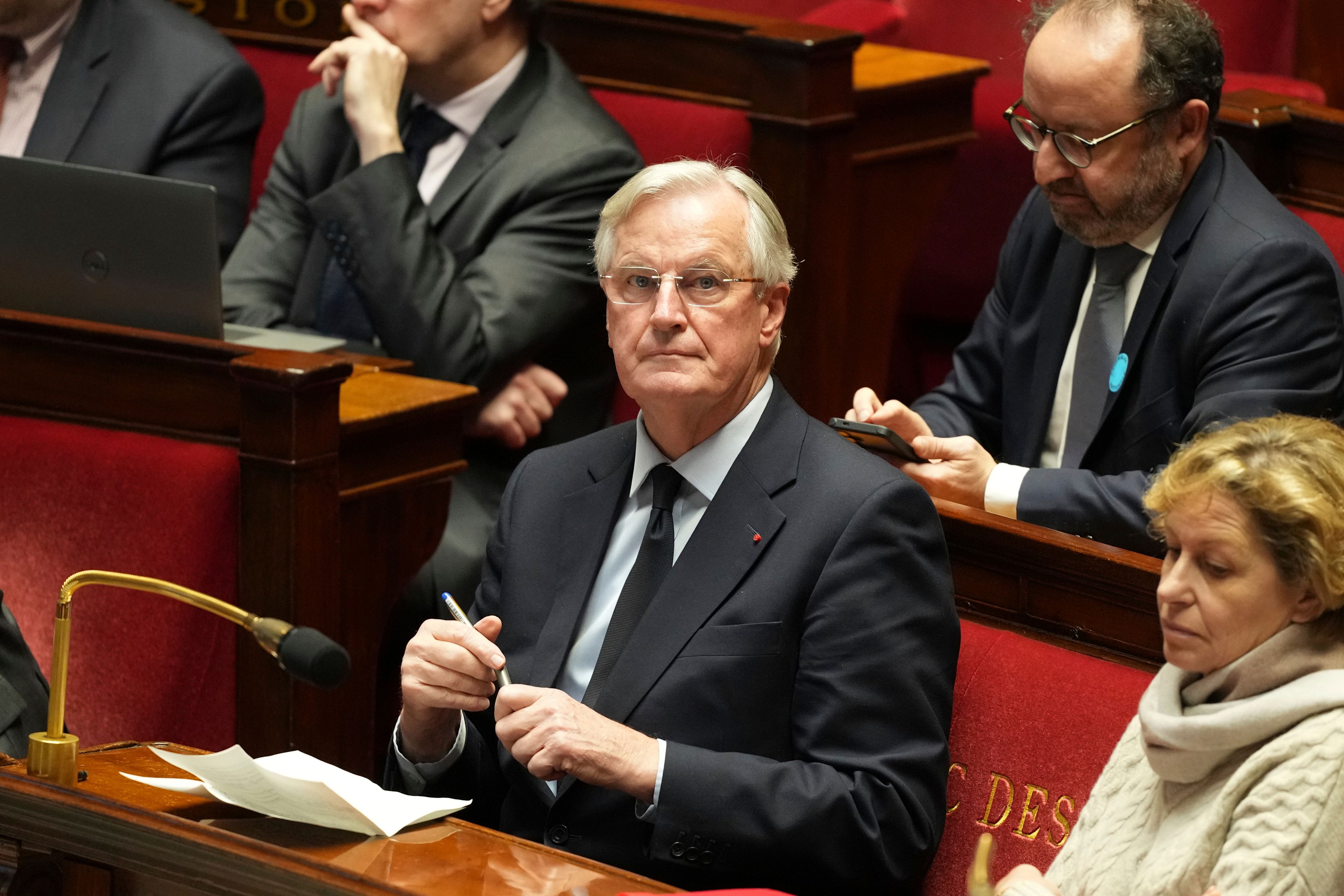 French Prime Minister Michel Barnier sits at the National Assembly while France's minority government may be on its last legs as opposition lawmakers moved this week toward a no-confidence vote, Monday, Dec. 2, 2024 in Paris. (AP Photo/Michel Euler)