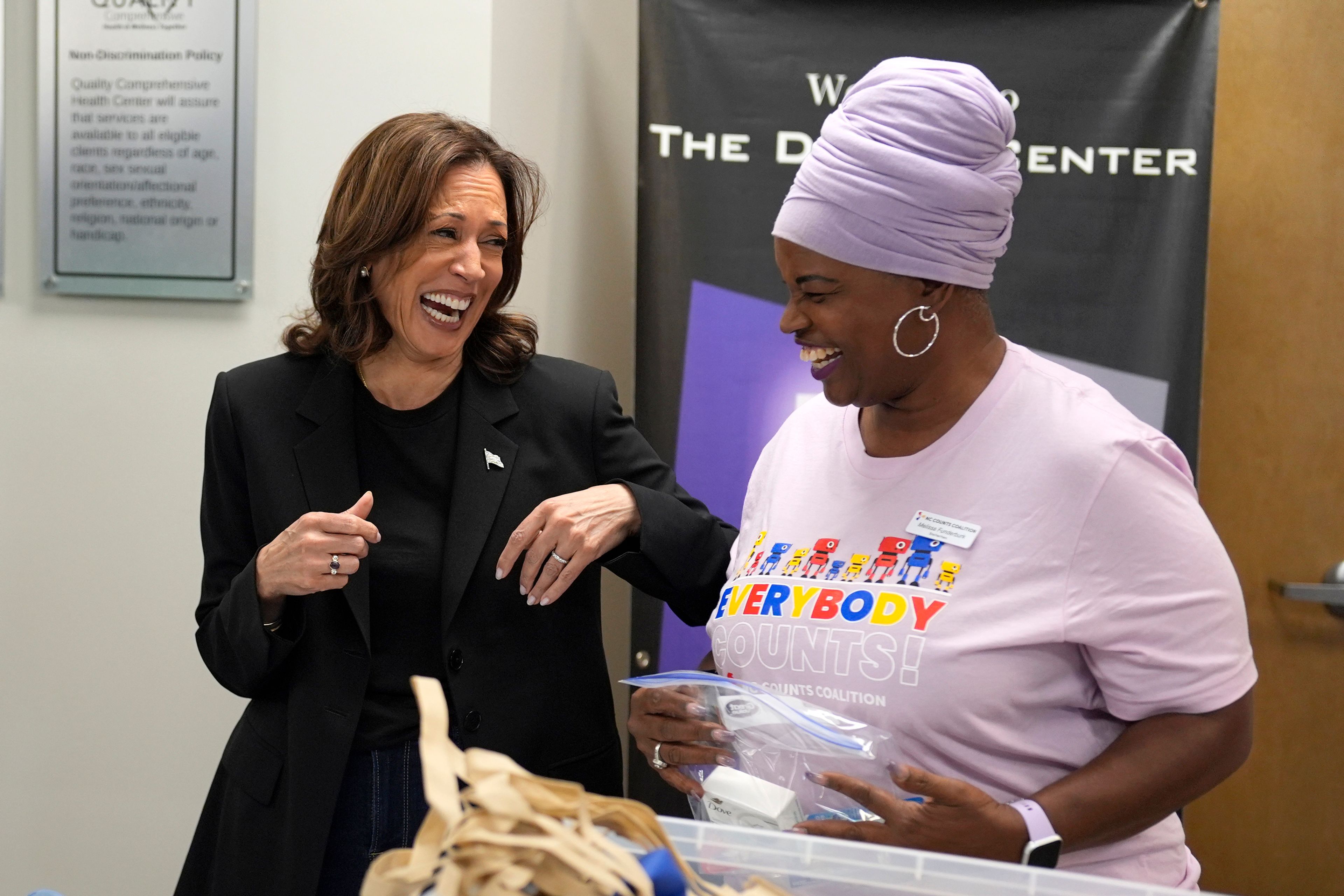 Democratic presidential nominee Vice President Kamala Harris, left, greets Melissa Funderburk, a worker at a food drop-off and distribution center, after receiving a briefing on the damage from Hurricane Helene, Saturday, October 5, 2024, in Charlotte, N.C. (AP Photo/Chris Carlson)