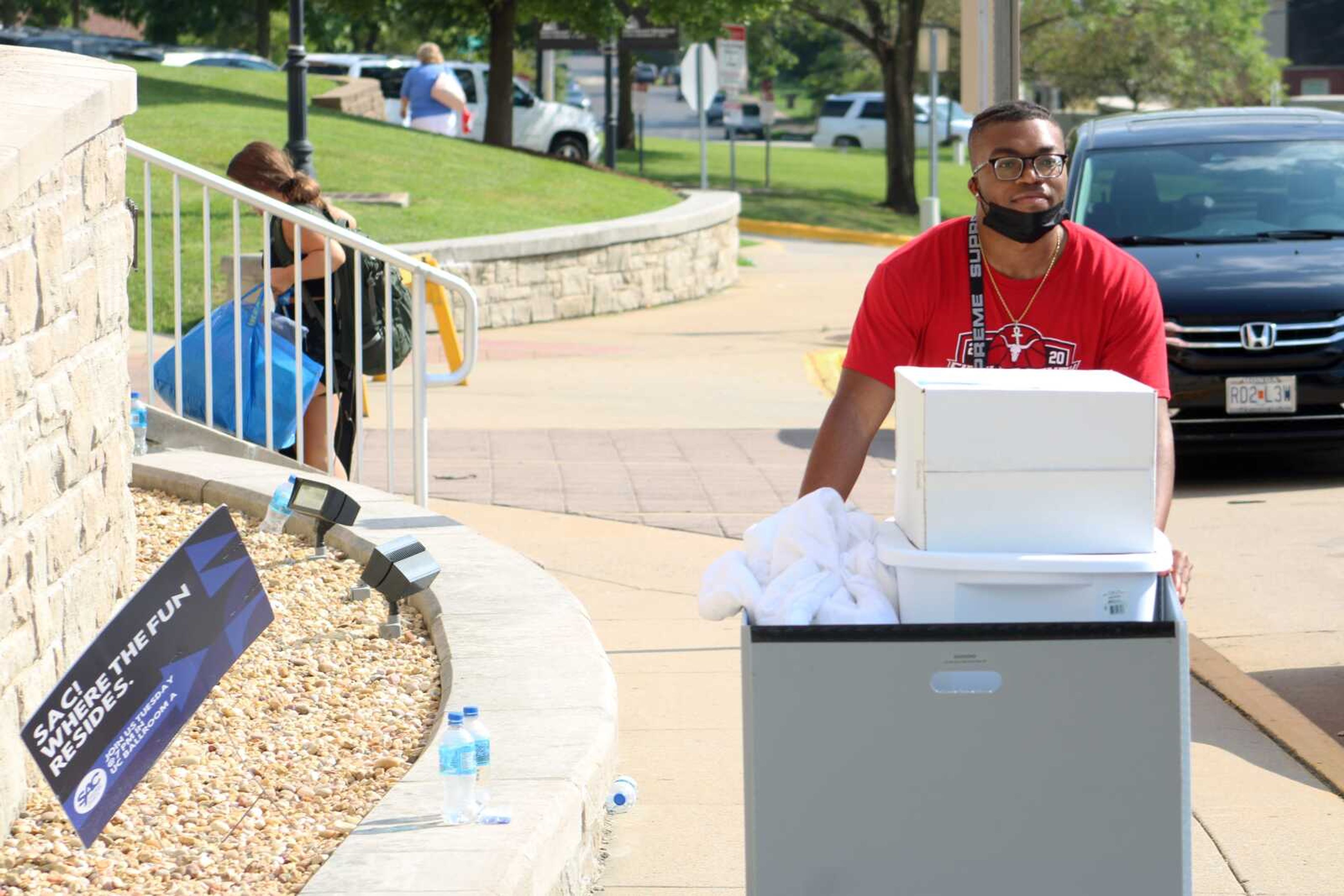 Southeast Missouri State University student John Powell pushes a cart full of belongings to a dorm room during SEMO's new student move-in day Aug. 19.