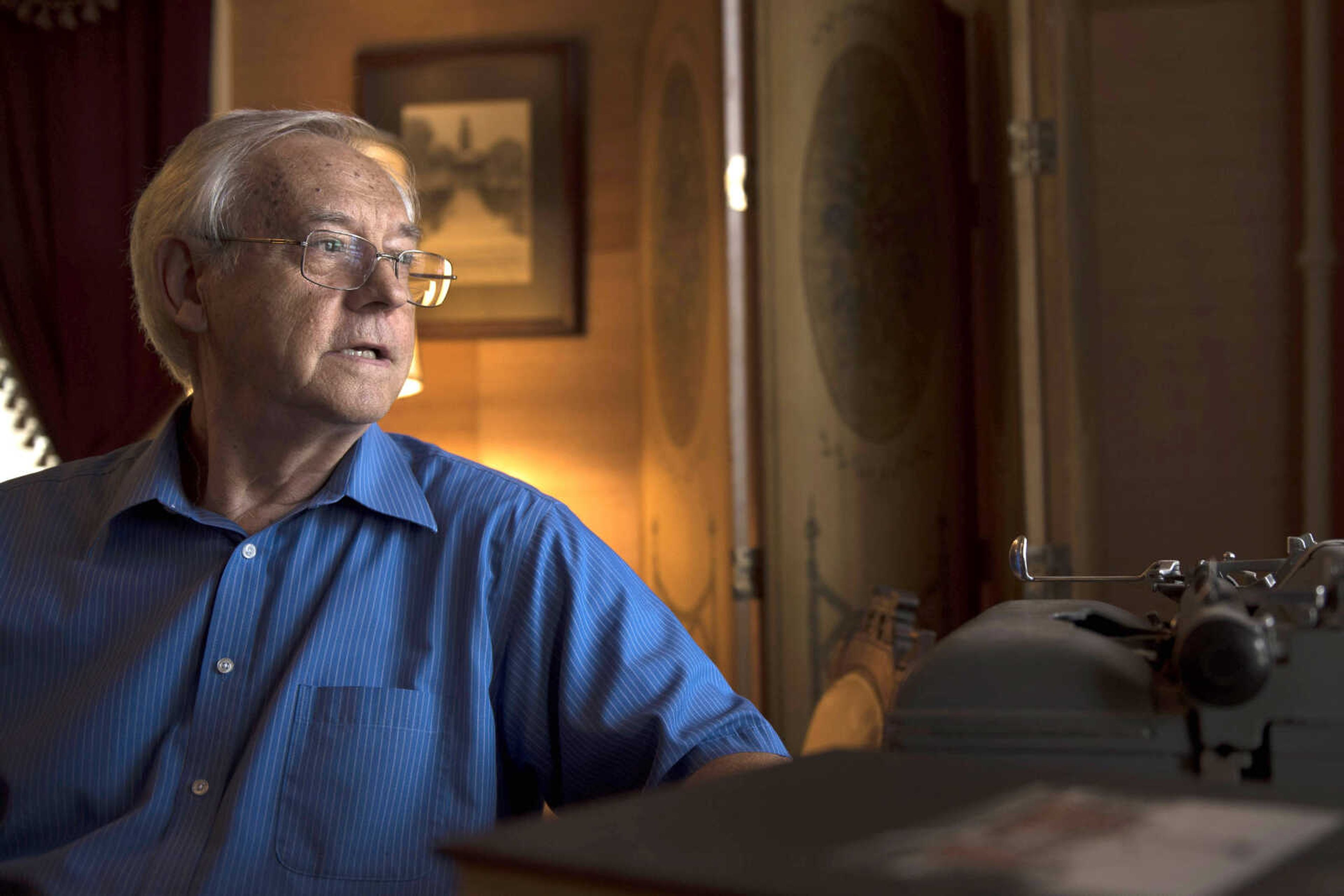 Robert Hamblin, professor emeritus of English at Southeast Missouri State University, sits for a portrait Monday at a desk in his home in front of a typewriter he shares with his wife, Kaye, and used to use for writing in October of 2018. (Southeast Missourian File Photo)