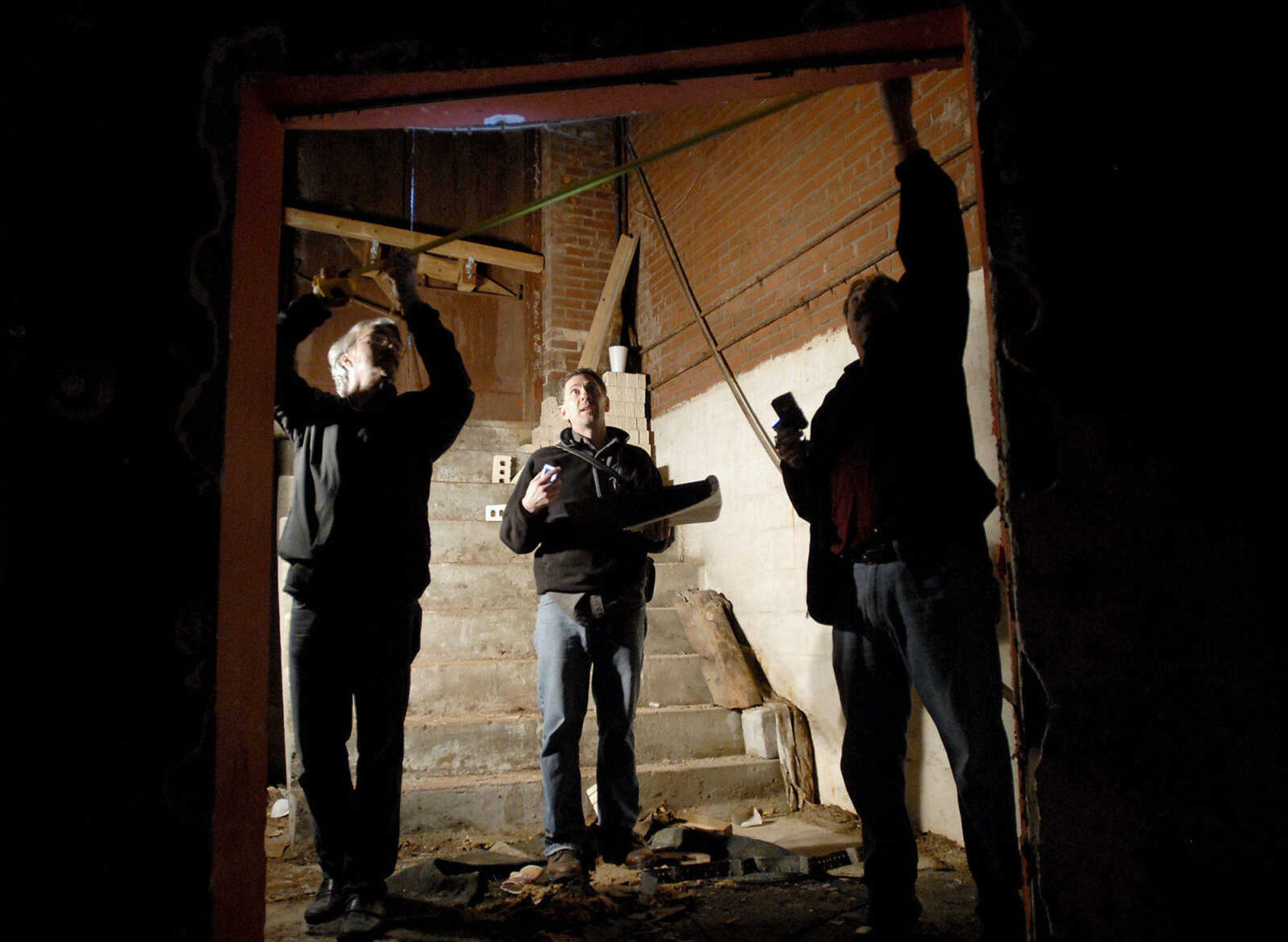 KRISTIN EBERTS ~ keberts@semissourian.com

From left, Kevin Flynn and David Leavy, of Kiku Obata & Company, and Glen Hinkebein, of Penzel Construction, work to take measurements of the Esquire Theater building on Friday, Jan. 6, 2012, in Cape Girardeau. Renovation work on the Esquire Theater continues as workers from Kiku Obata & Company and Penzel Construction complete field verification work and take measurements necessary for the design plans.