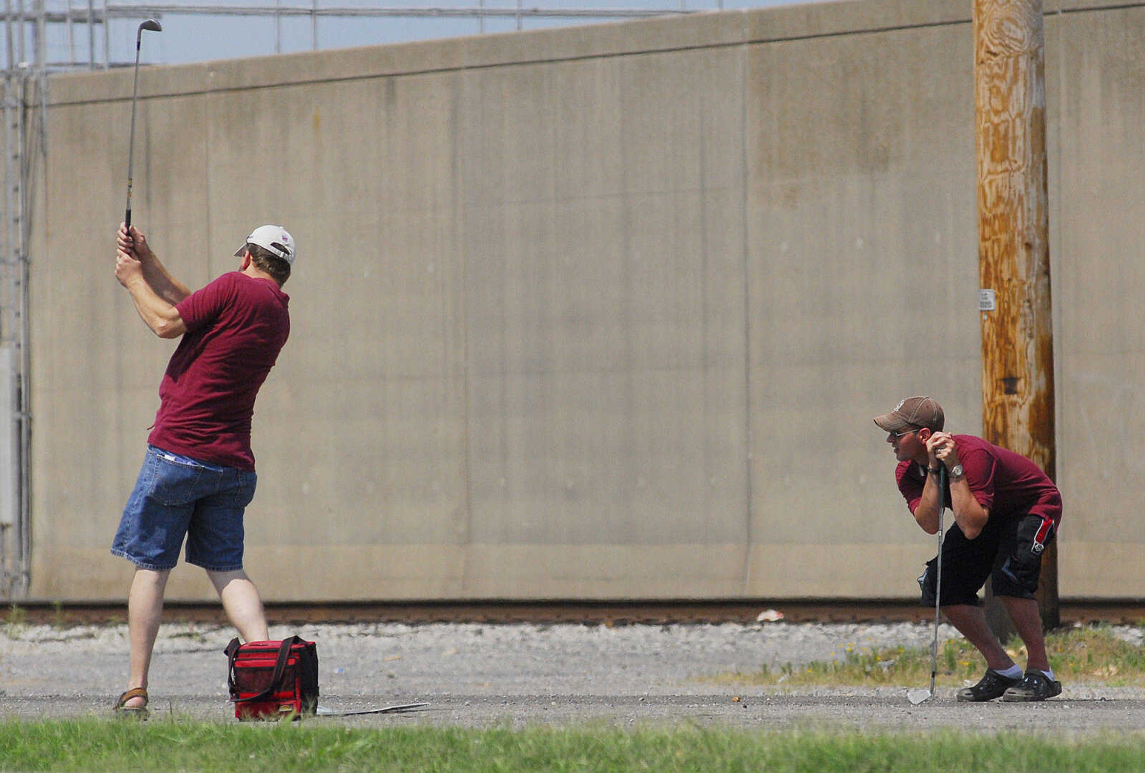 LAURA SIMON~lsimon@semissourian.com
Justin Carruthers, right, watches as Tom VanderFeen drives his BirdieBall along the flood wall Sunday, June 27, 2010 during the First-Ever Fifth Annual Louis J. Lorimier World Famous Downtown Golf Tournament in Cape Girardeau.