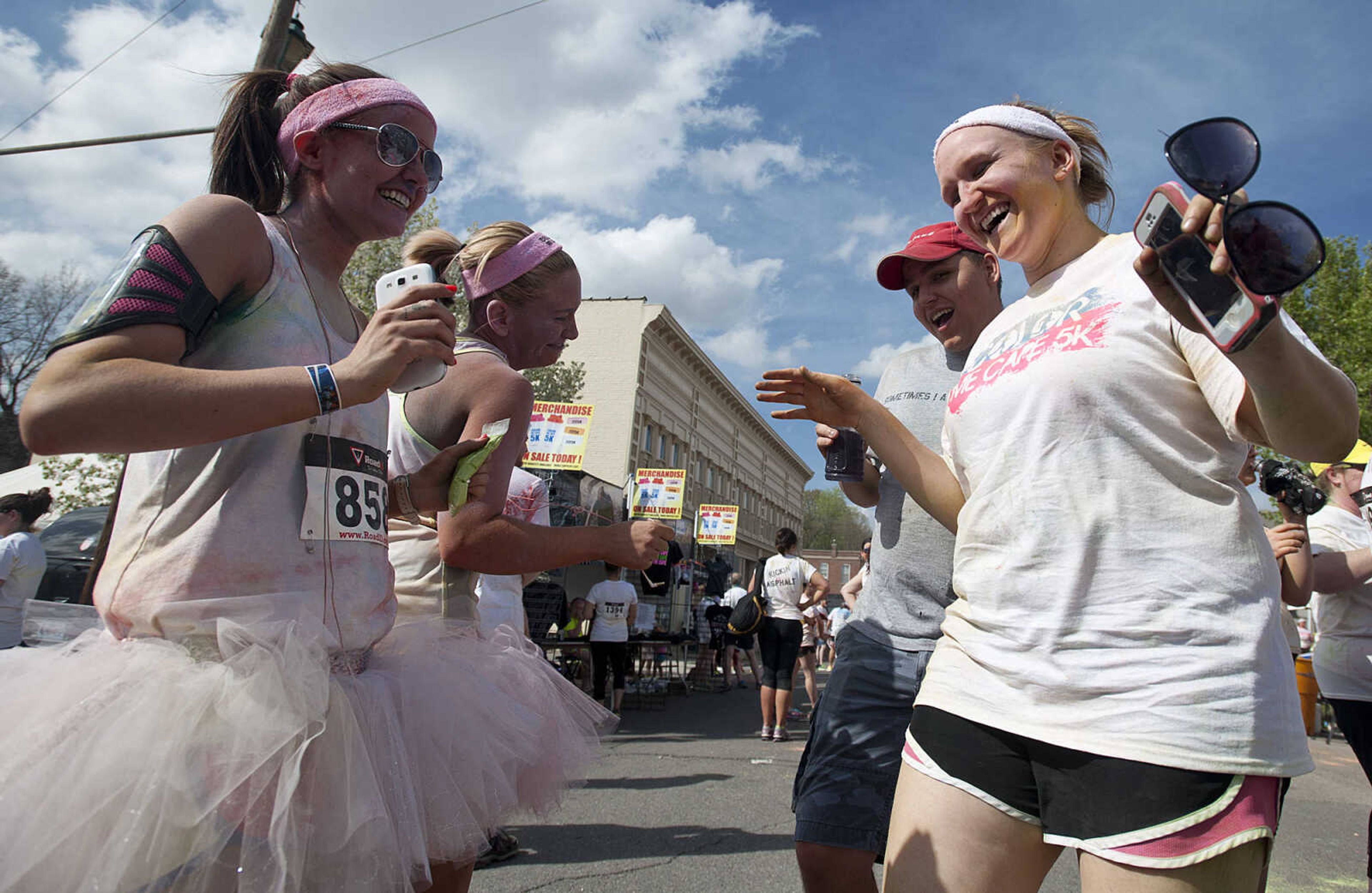 ADAM VOGLER ~ avogler@semissourian.com
Brittni Kinder, left, Chrissy Arthur, Alex Friedrich and Sarah Ressel dance in the street in froth of the Bel Air Grill after the Color Me Cape 5k Saturday, April 12, in Cape Girardeau.