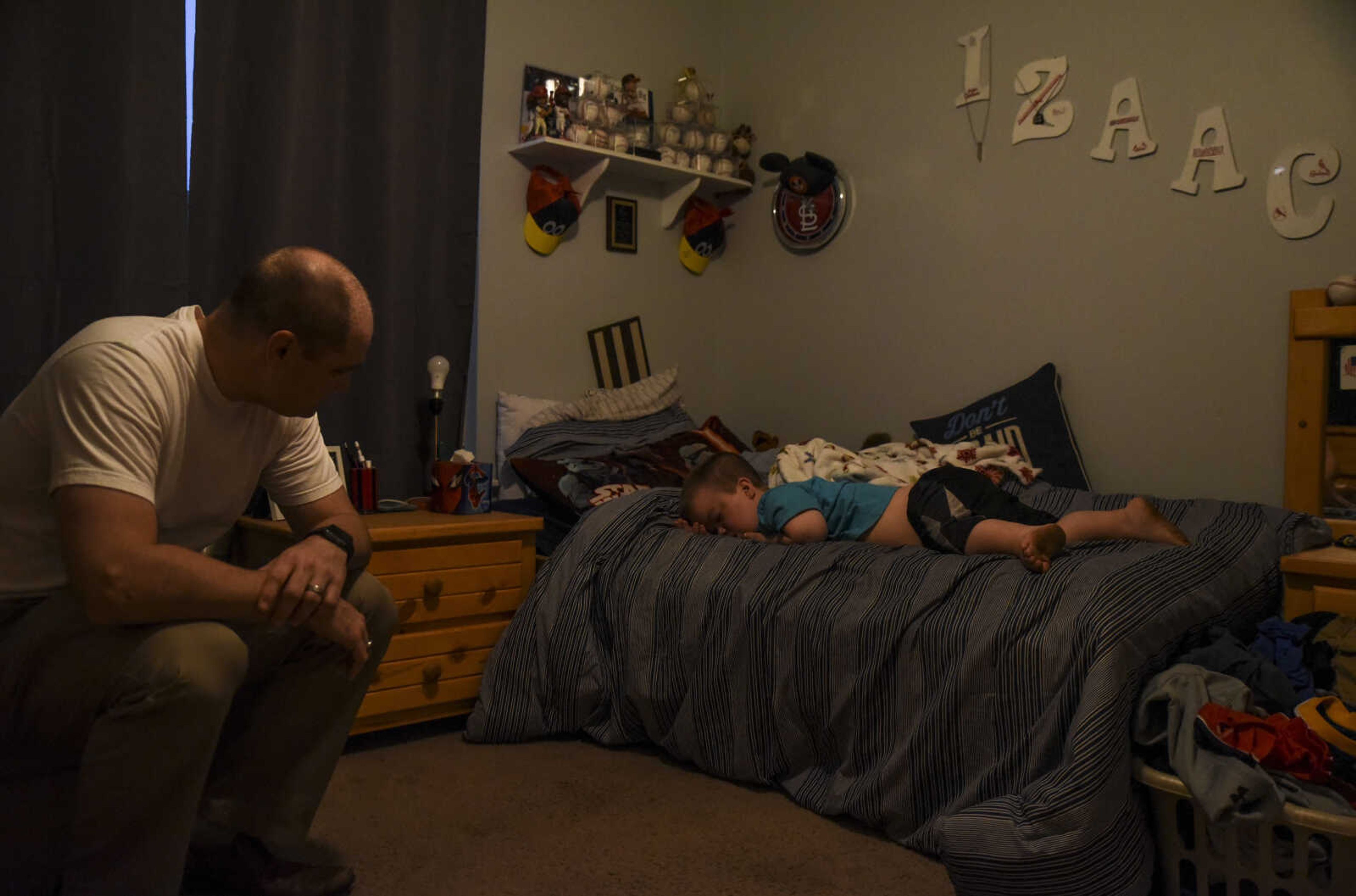 Greg Pursley, left, sits while waiting for his son Izaac Pursley to wake up to get ready for school May 3, 2018, at their home in Jackson.