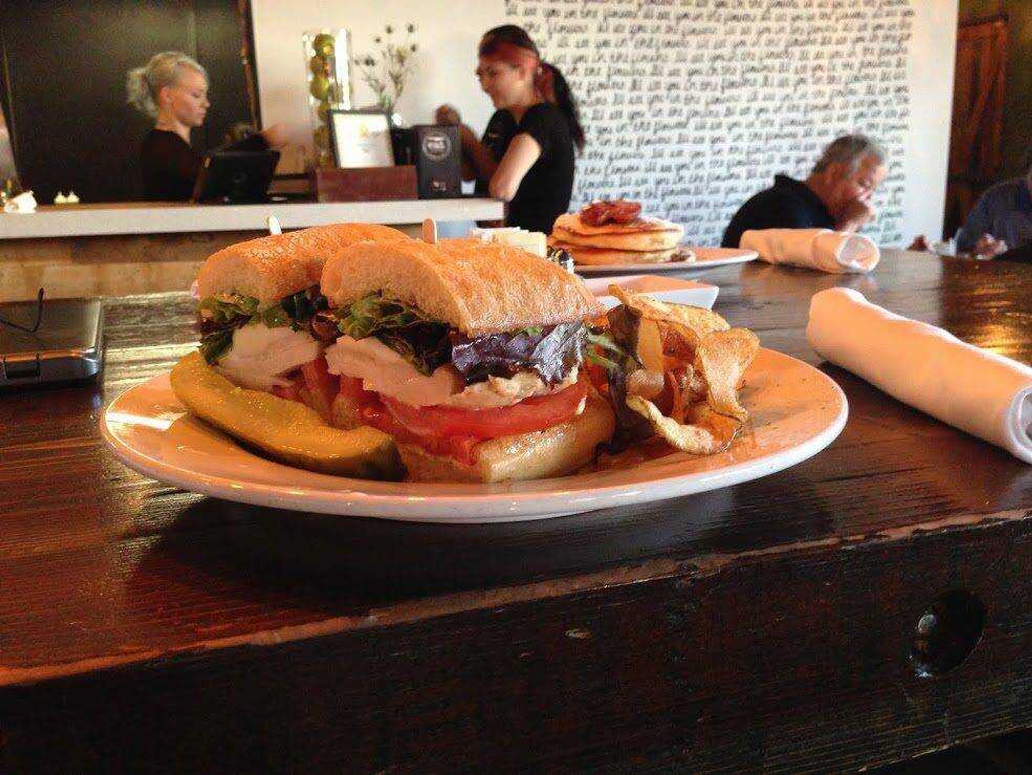 This March 21 photo shows a chicken sandwich with pan-seared free-range chicken, fresh mozzarella, tomato, local baby greens and pesto mayo on ciabatta at Eat in Las Vegas. Eat is part of a boom in cozy neighborhood restaurants in what was once the derelict core of Las Vegas. Chef and owner Natalie Young says she designed the restaurant as an alternative to the glitzier cuisine on the Strip. (Hannah Drier ~ Associated Press)