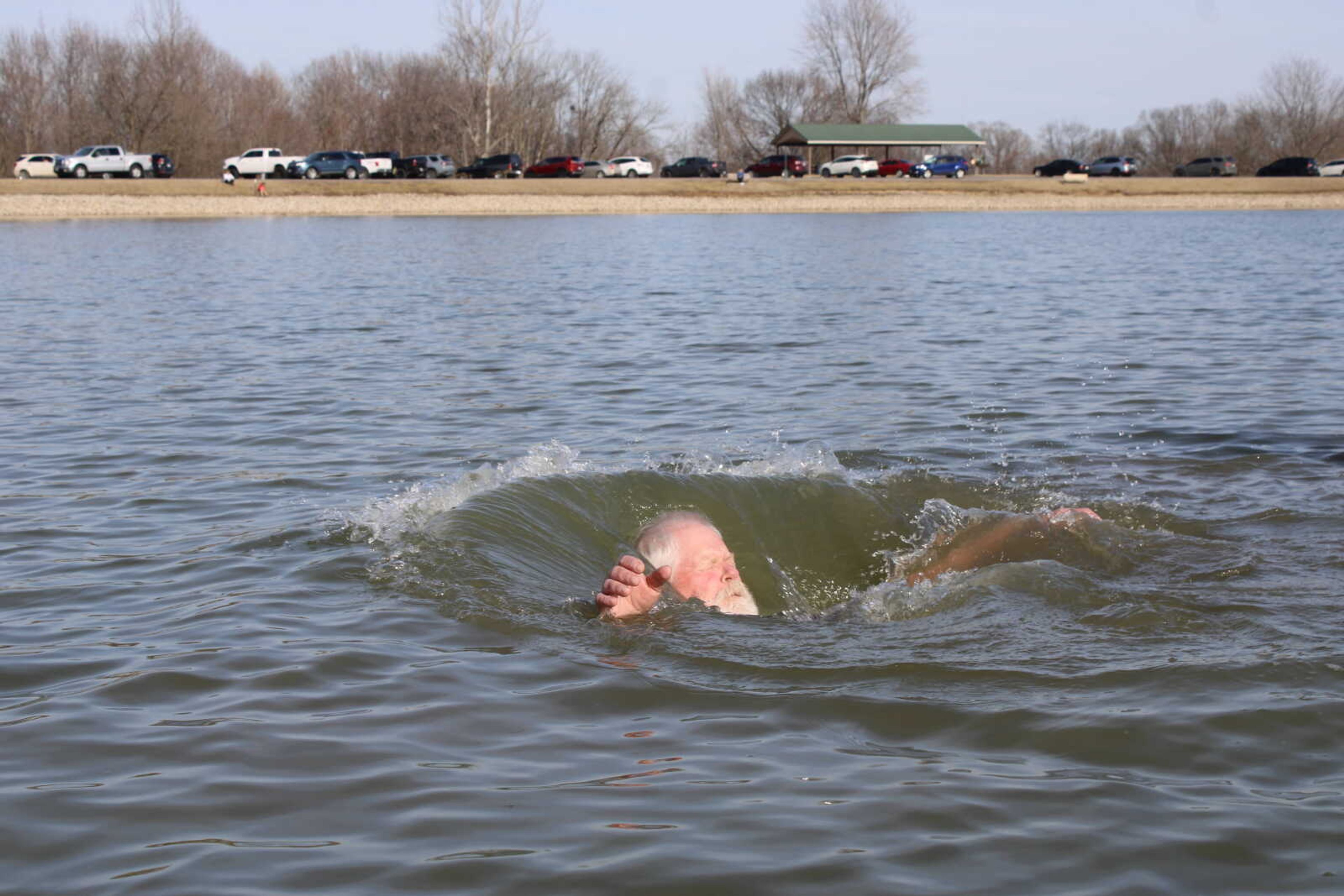 Polar Plunge participant throws himself back into the water