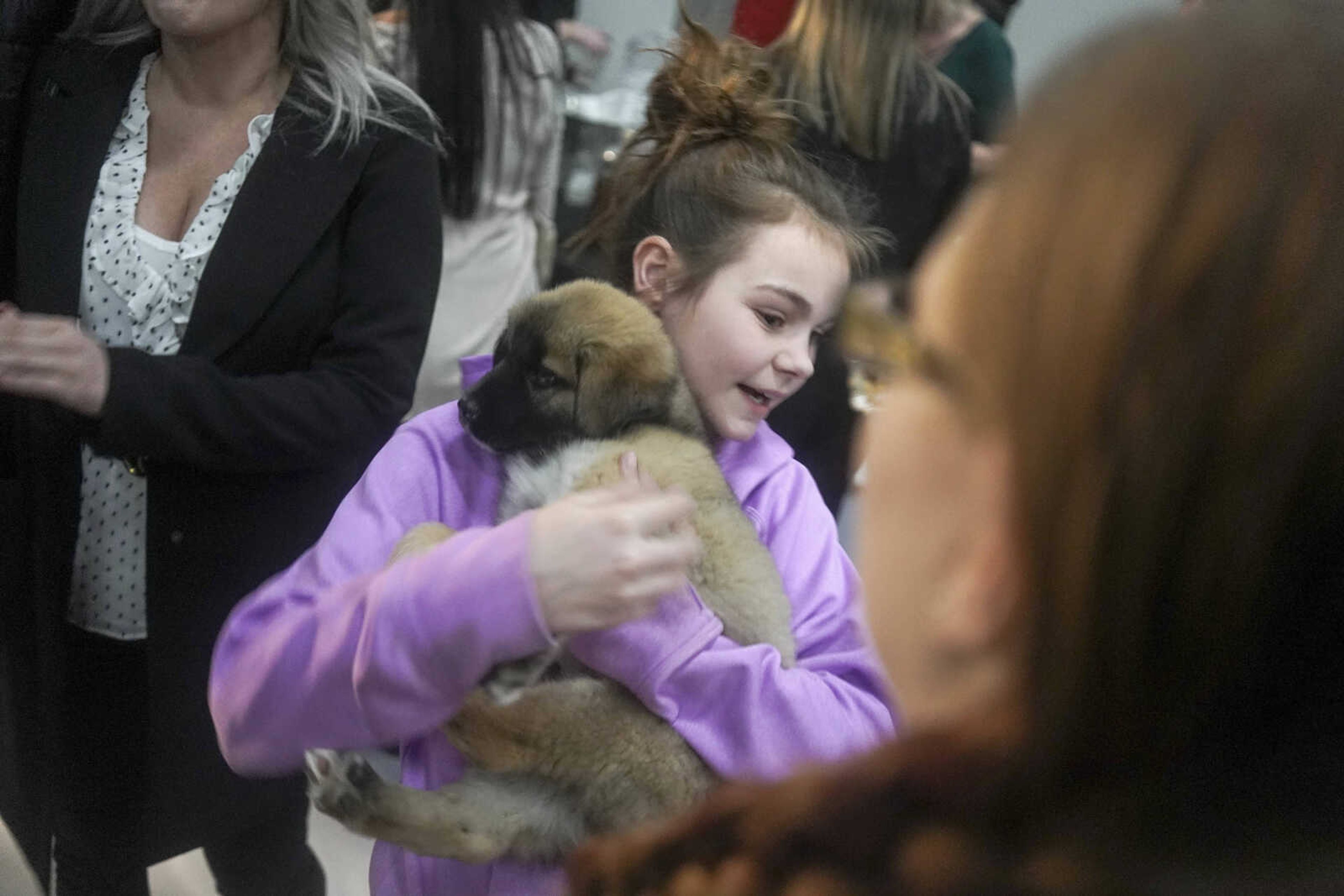 Layla Blechle holds a puppy during the Humane Society of Southeast Missouri Power of Pawsitivity fundraiser Saturday, Feb. 29, 2020, at the Jackson Civic Center in Jackson.