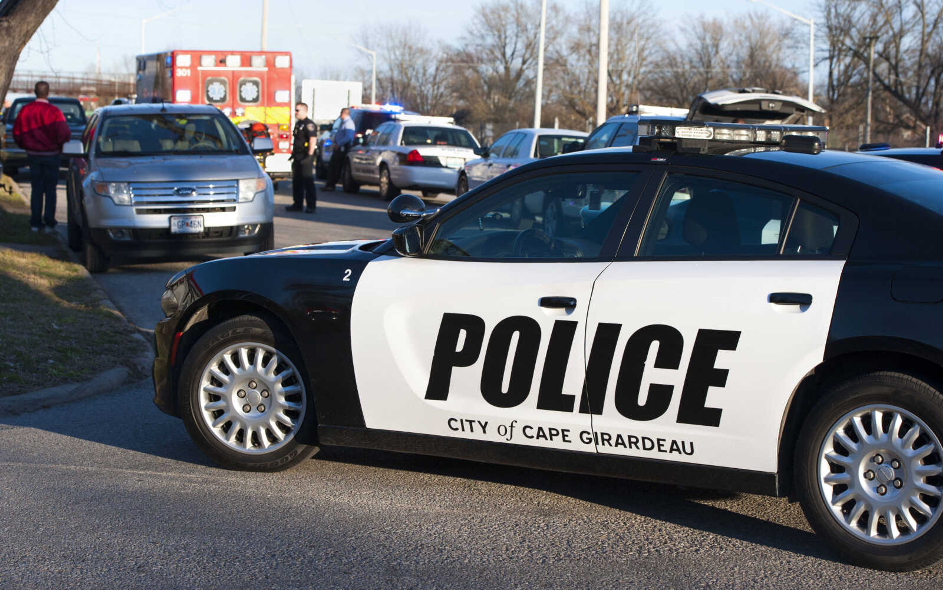 Parked patrol vehicles divert traffic from the 900 block of College Street as Cape Girardeau police officers investigate a shooting Tuesday, March 3, 2020, in Cape Girardeau.