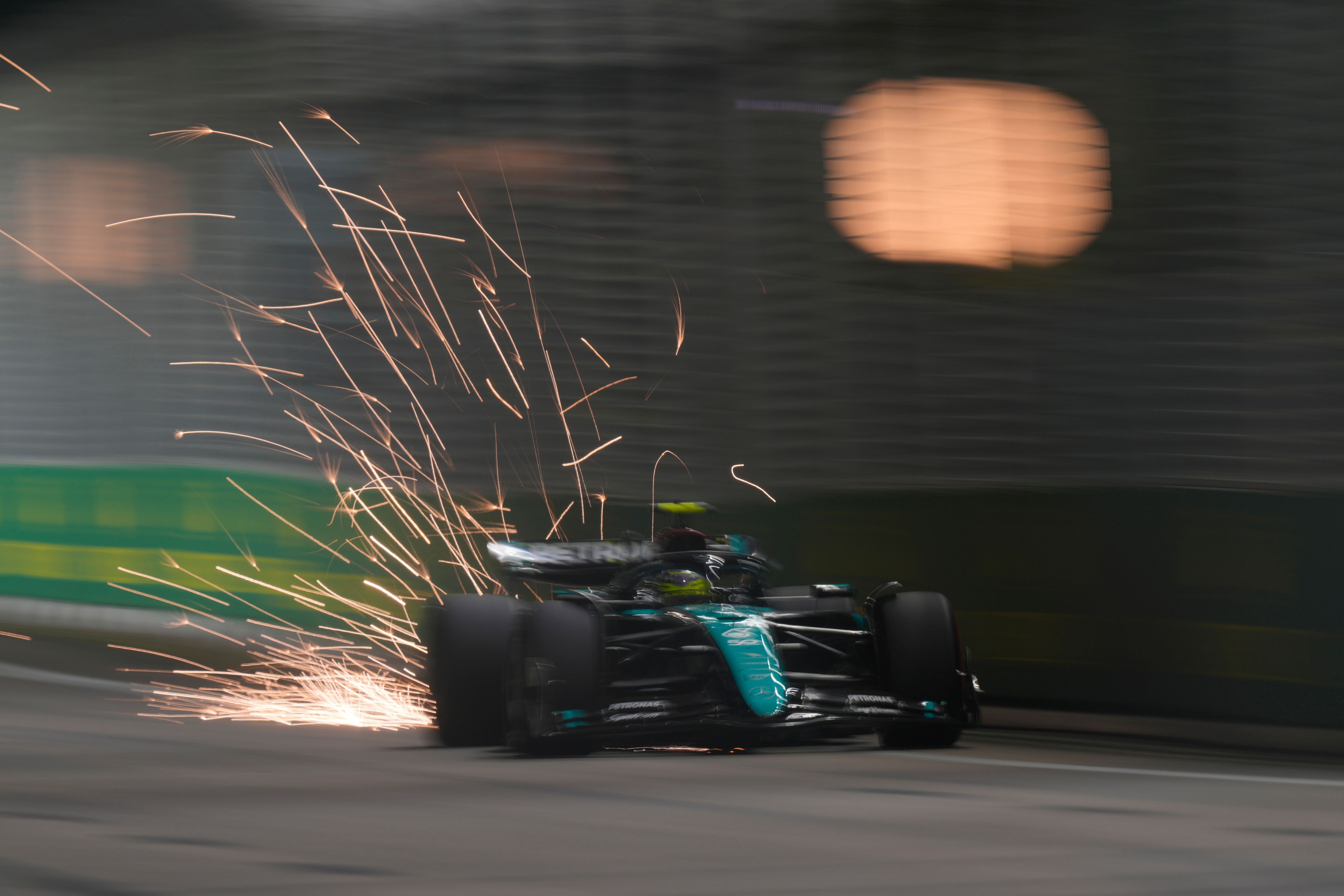 Mercedes driver Lewis Hamilton of Britain steers his car during the qualifying session of the Singapore Formula One Grand Prix at the Marina Bay Street Circuit, in Singapore, Saturday, Sept. 21, 2024. (AP Photo/Vincent Thian)