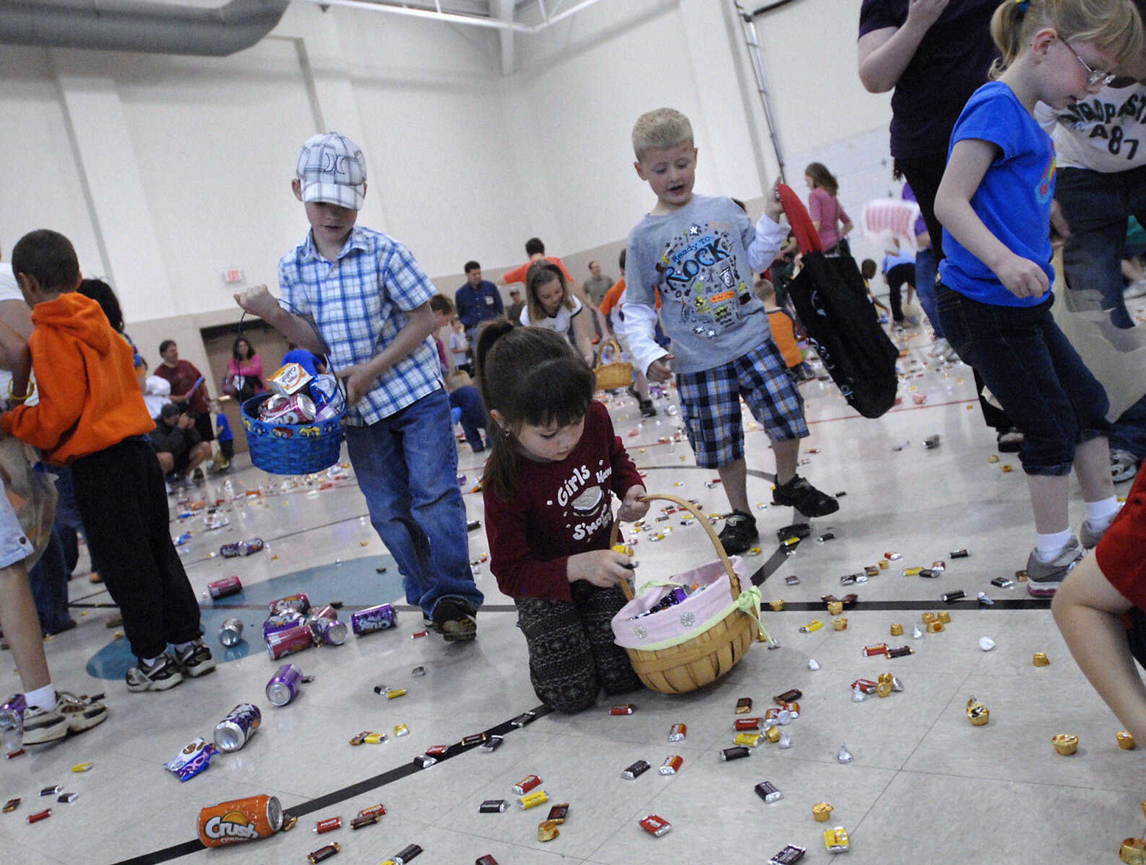 KRISTIN EBERTS ~ keberts@semissourian.com

Kids sweep up goodies during the Schnucks Pepsi Easter egg hunt at the Osage Center on Saturday, April 23, 2011, in Cape Girardeau. Kids ages 2-7 turned out to collect an array of soda, chips, cookies and candy during the hunt.