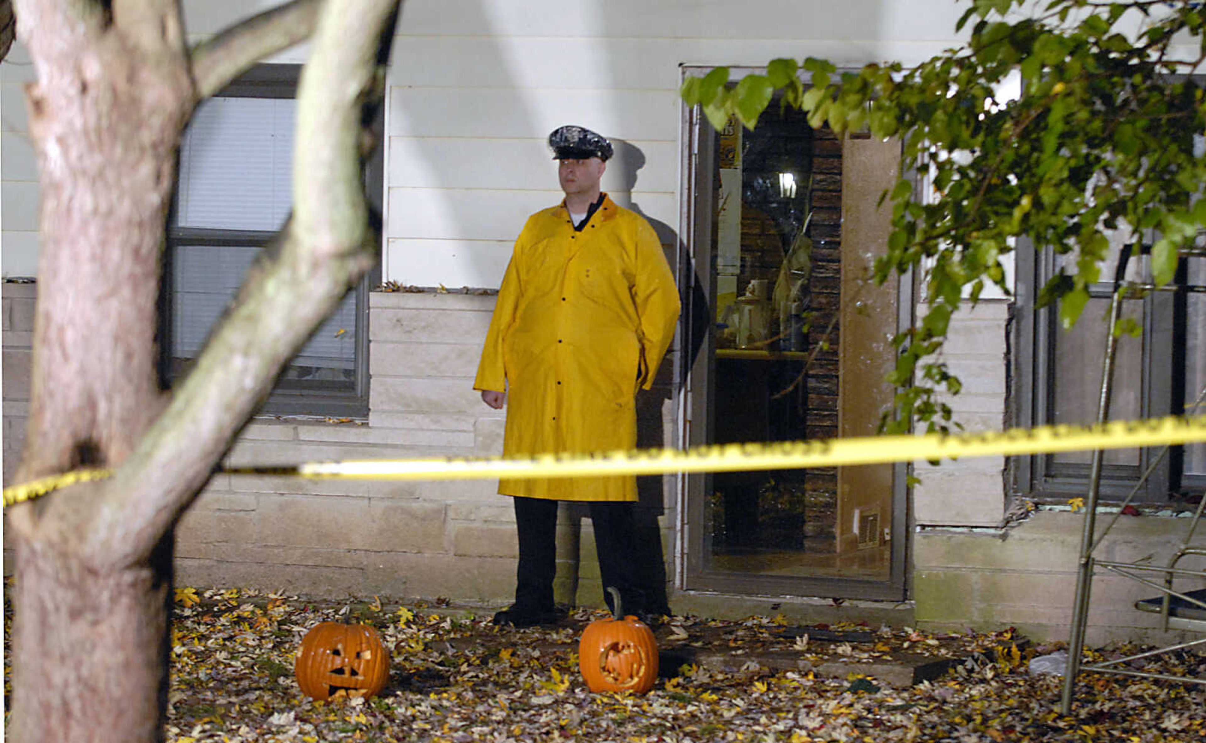 KIT DOYLE ~ kdoyle@semissourian.com
Cape Girardeau policeman Aaron Brown stands in front of 1224 N. Missouri St., the scene of a double homicide near Capaha Park early Tuesday morning.