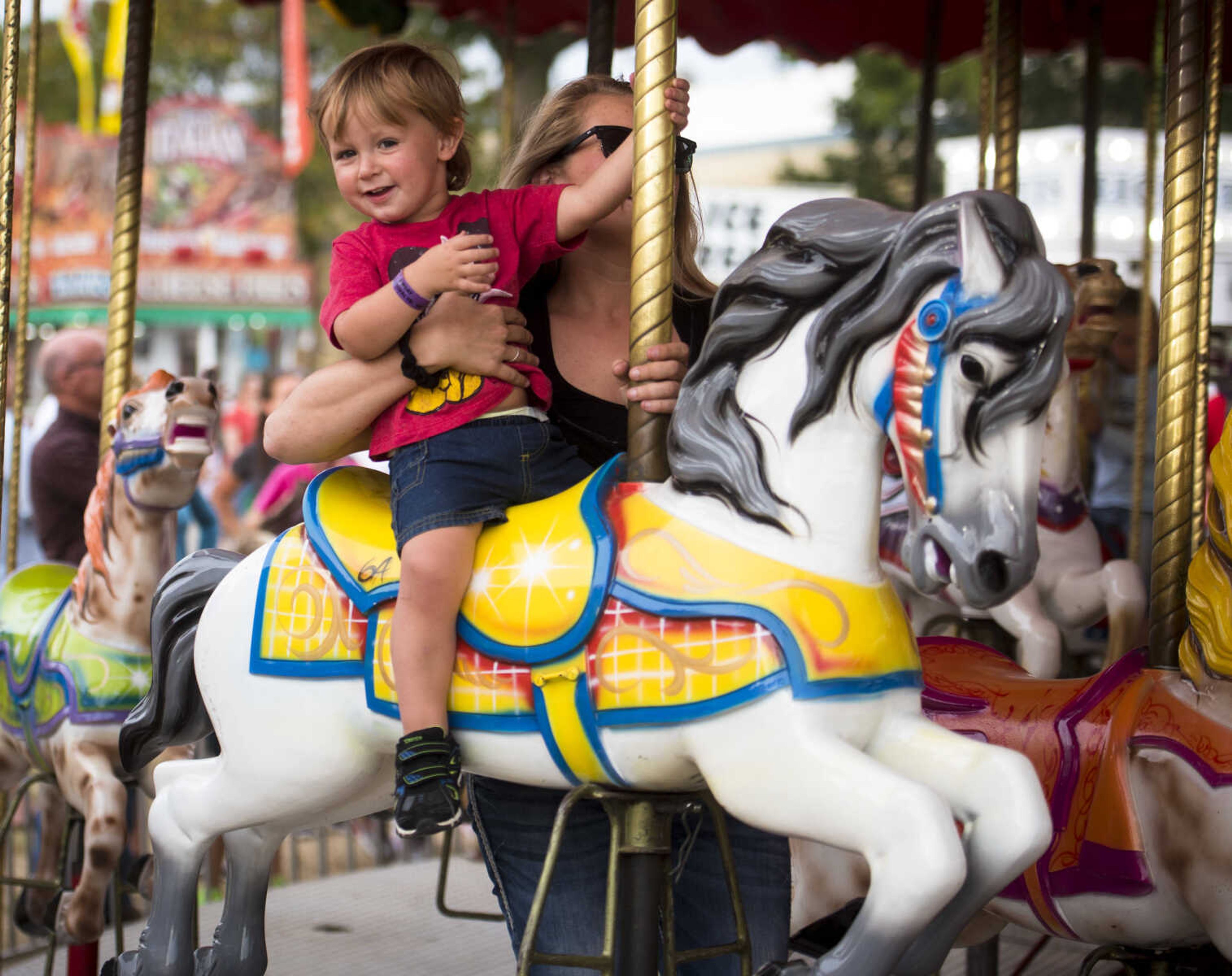 Braxtyn Moore, 2, rides the carousel at the SEMO District Fair on September 11, 2017, in Cape Girardeau.