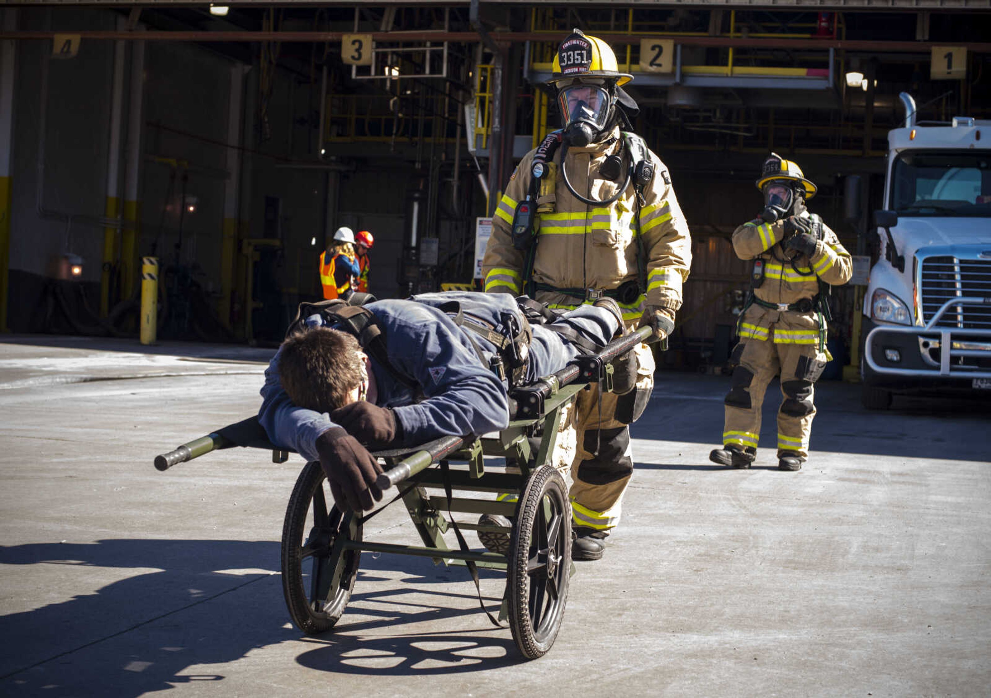 Mock victim Corey Gettings is taken away by SEMO Homeland Security Response Team members Ron Kiplinger, center, and Justin Farrar, right, during hazmat training on Wednesday, Oct. 17, 2018 at the Cape Girardeau Buzzi Unicem cement plant.