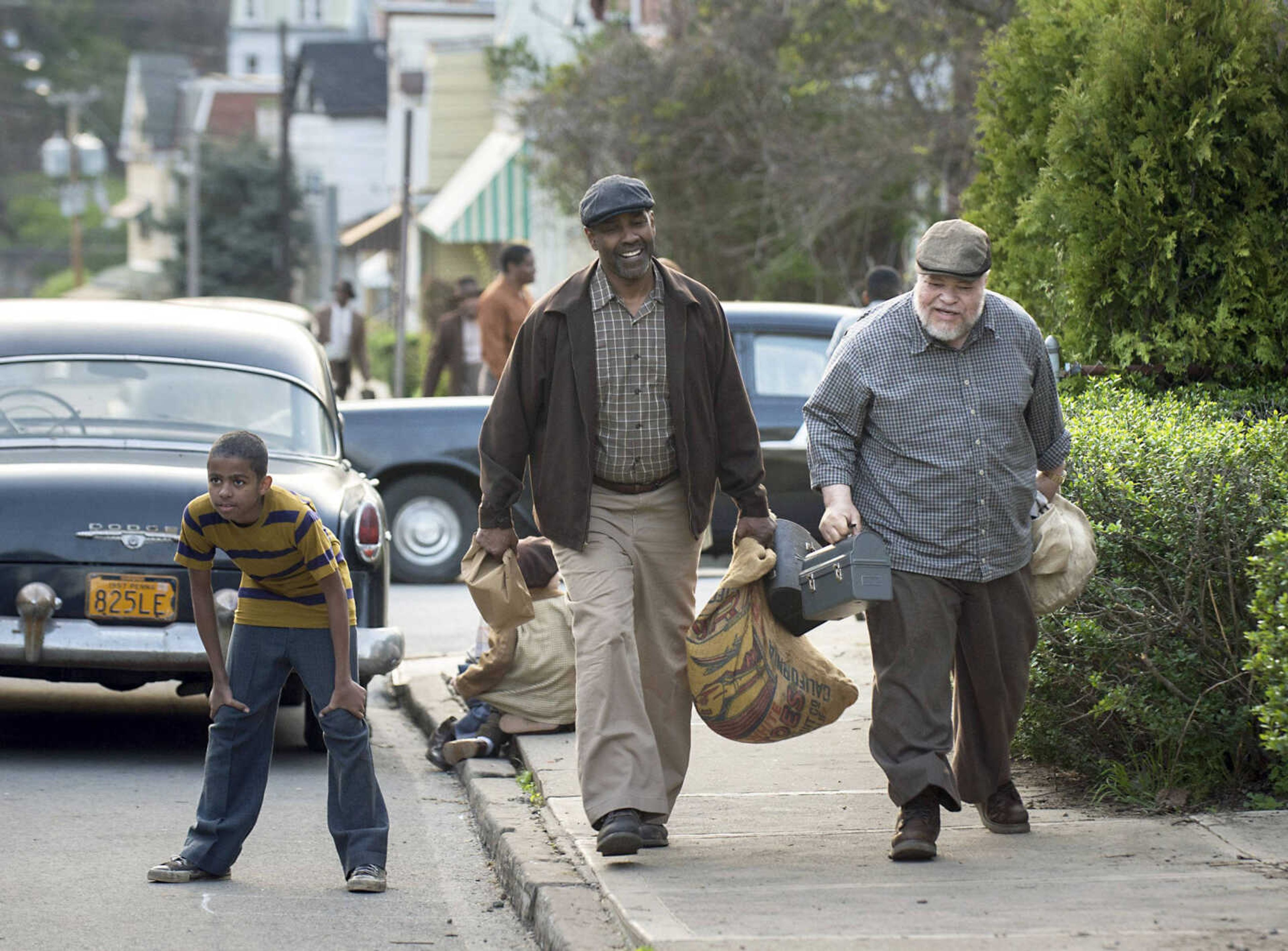 This image shows Washington, center, and Stephen McKinley Henderson, right, in a scene from "Fences."