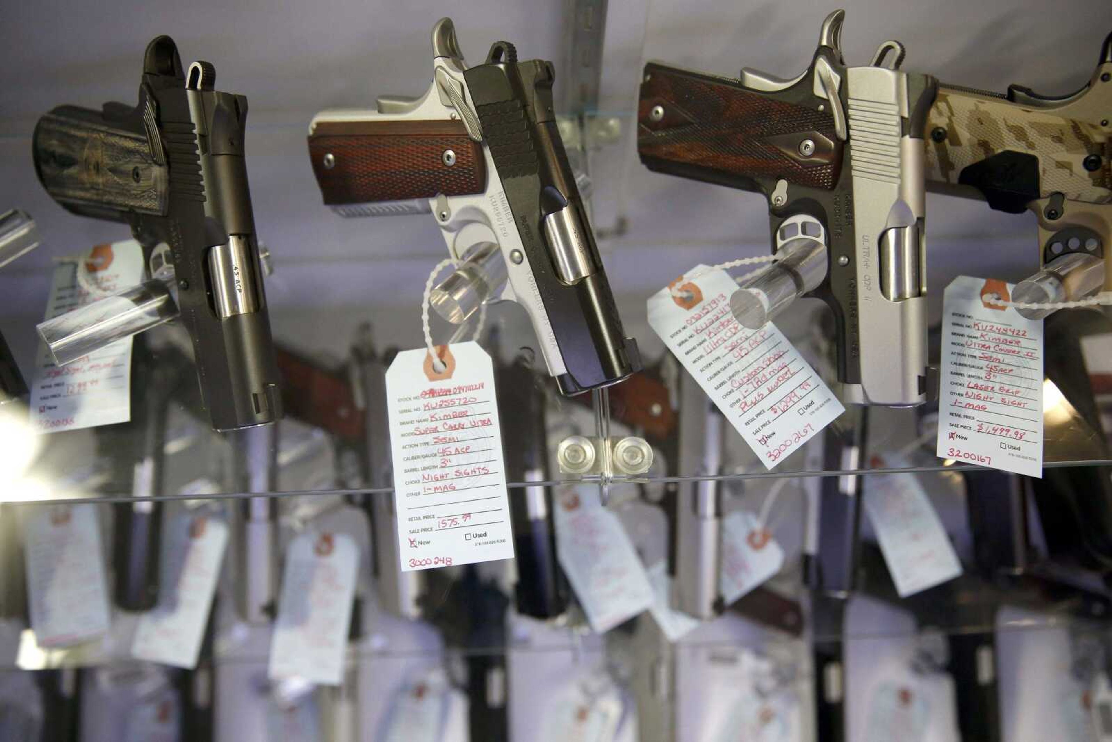 Handguns are shown in a display case at Metro Shooting Supplies in Bridgeton, Missouri. Gun sales have spiked in the region in the past year, and so have applications for concealed-carry permits.  Policing experts say with more guns come more gun thefts. (Jeff Roberson ~ Associated Press)